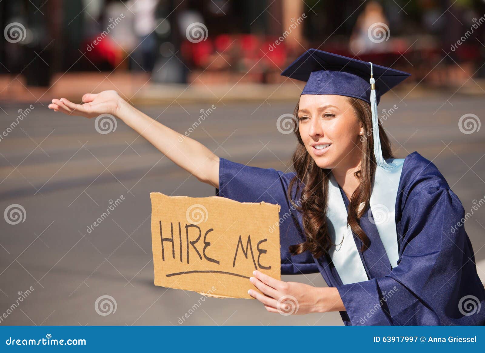 graduate with hire me sign