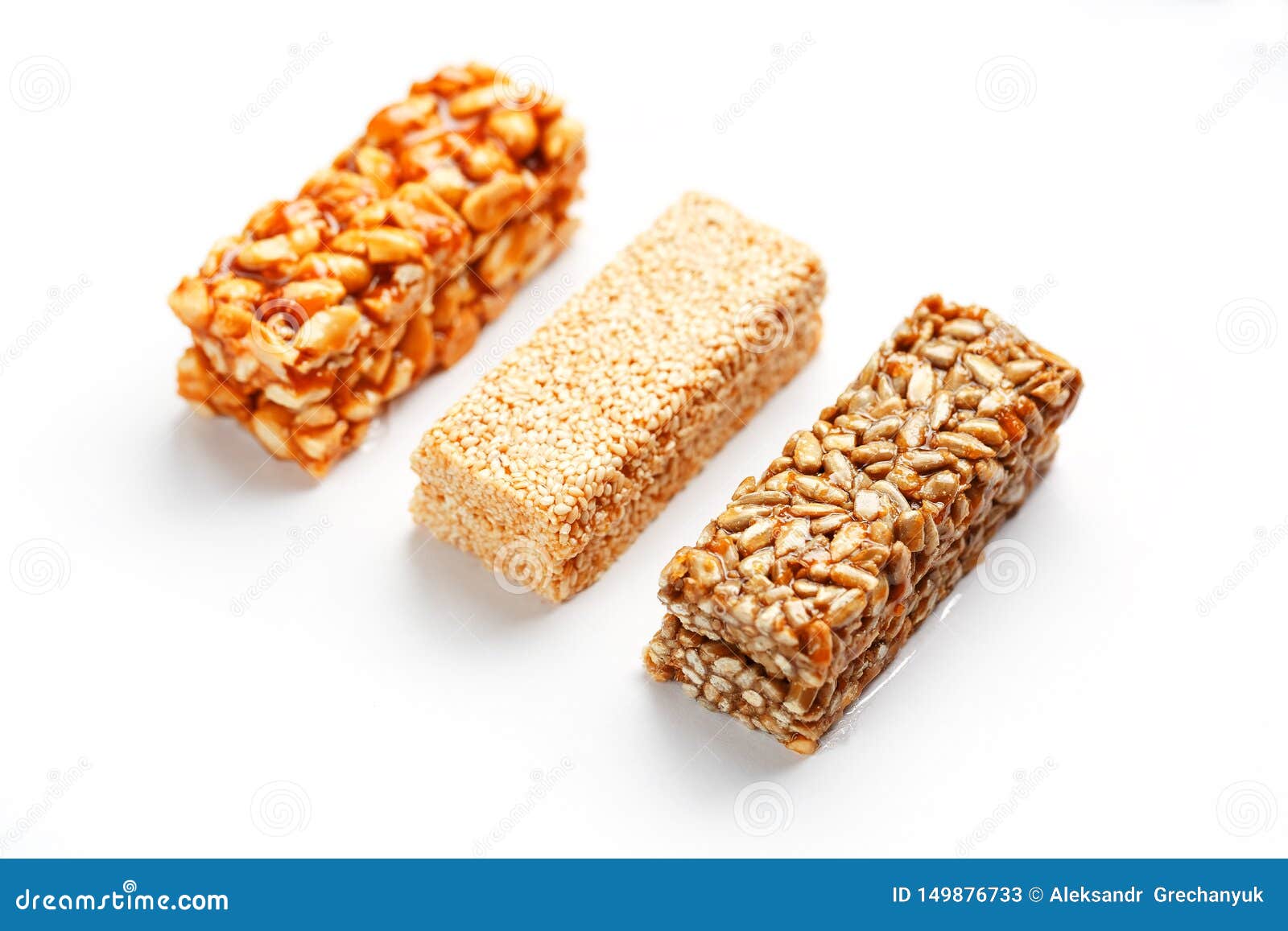 Grain Granola Bar with Peanuts, Sesame and Seeds in a Row on a White