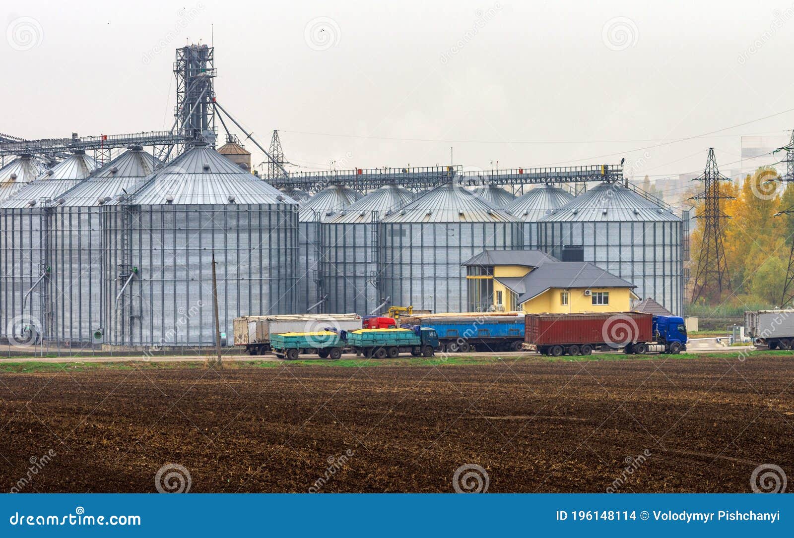 Grain Trucks In Front Of The Grain Warehouse. Stock Photography