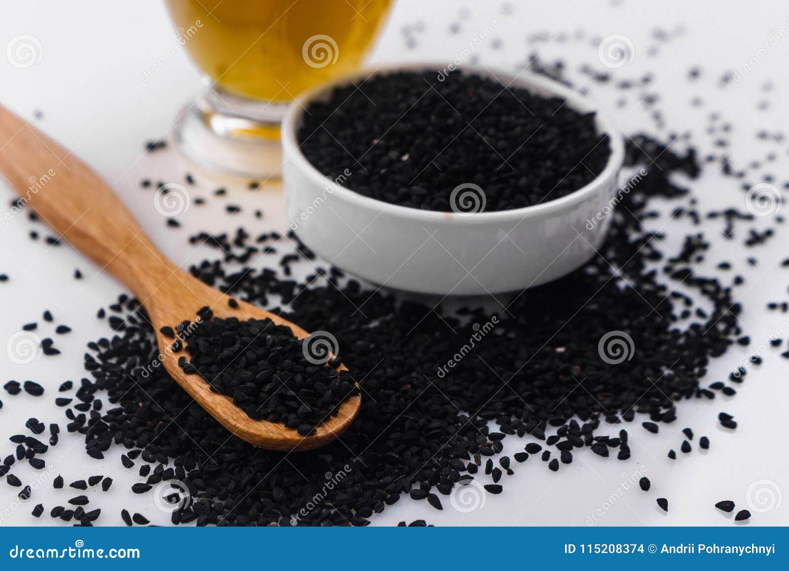 Grains of Black Cumin and Oil on the Rustic Background Stock Photo ...