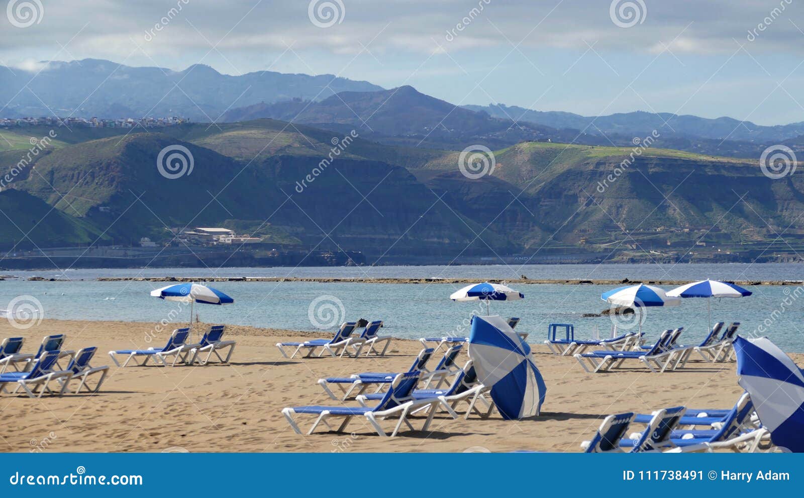 gran canaria - spain, sandy beach with sunbeds and umbrellas