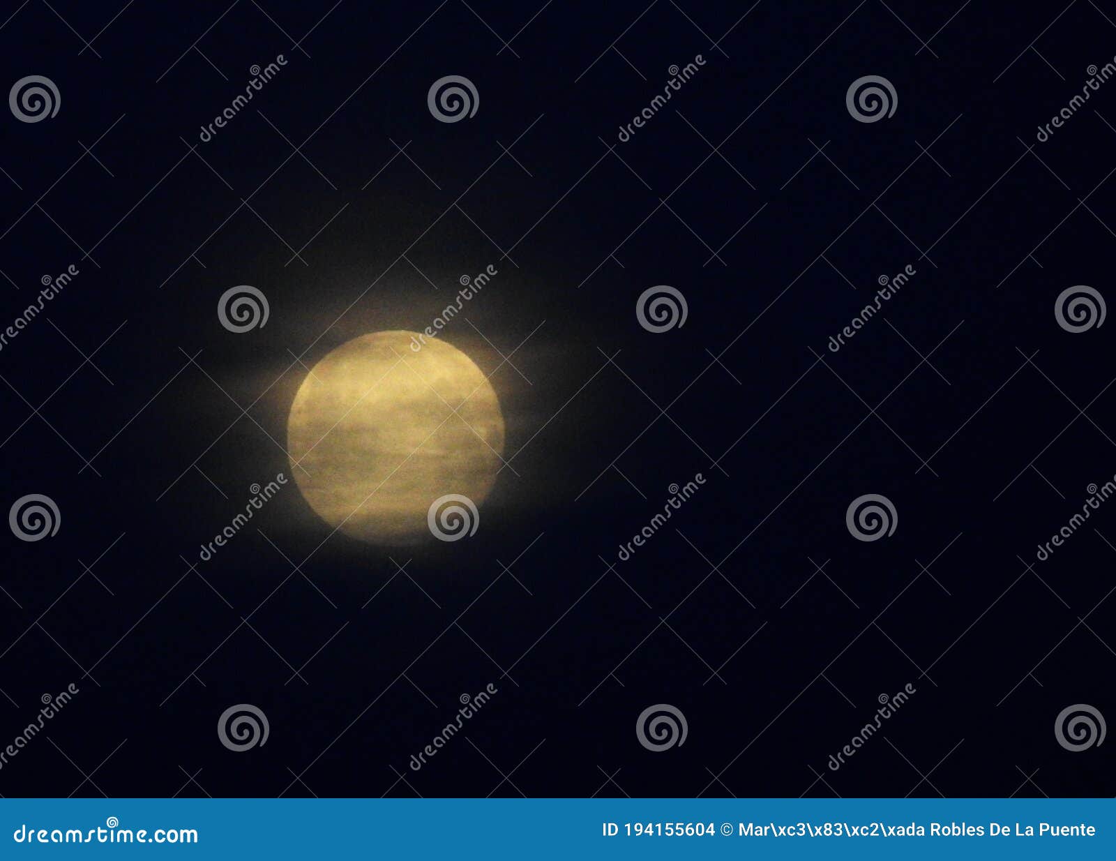 gran luna al amanecer con nubes deshechas pasando