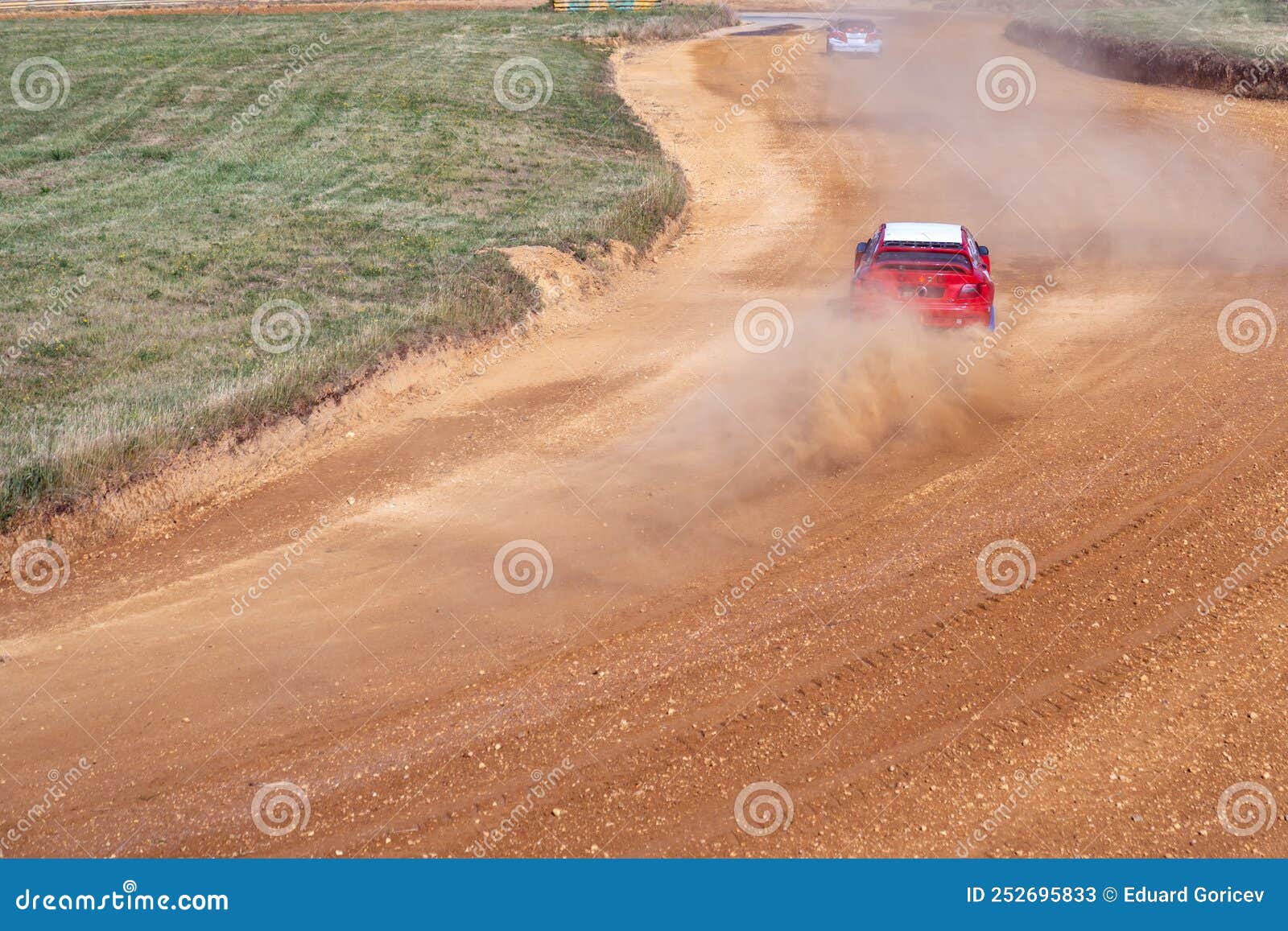 gran turismo races on the autocross track, skidding, dust and dirt from under the tires