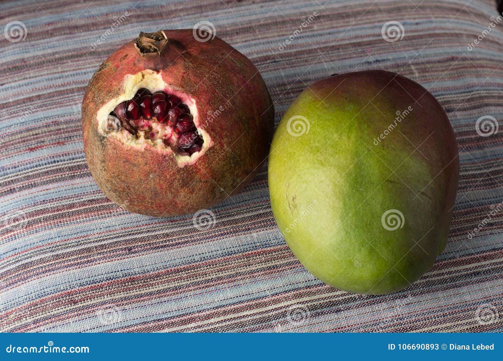 Зрелые и вкусные granate и манго на таблице
