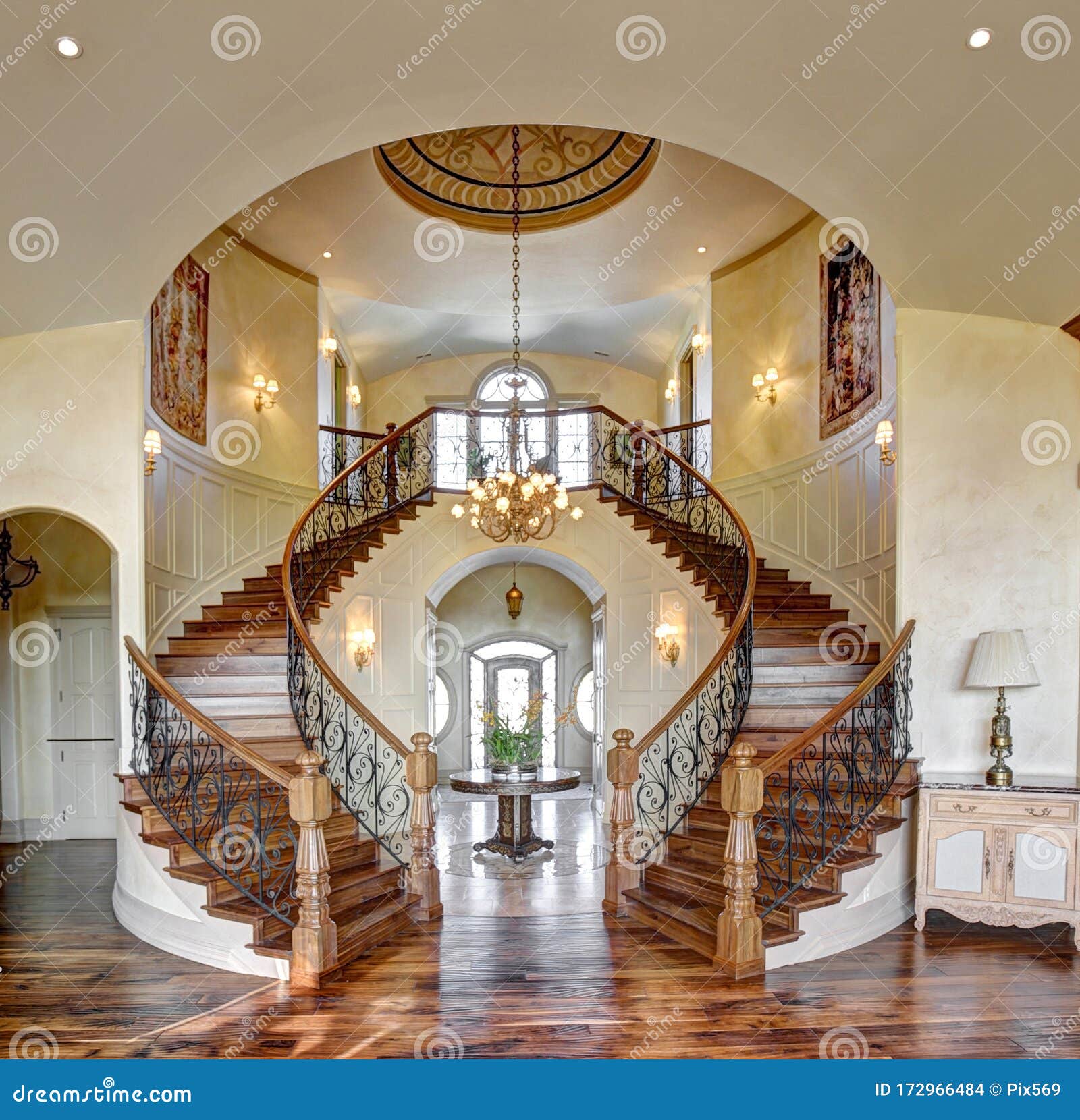 the curved dual grand staircase in an upscale home.