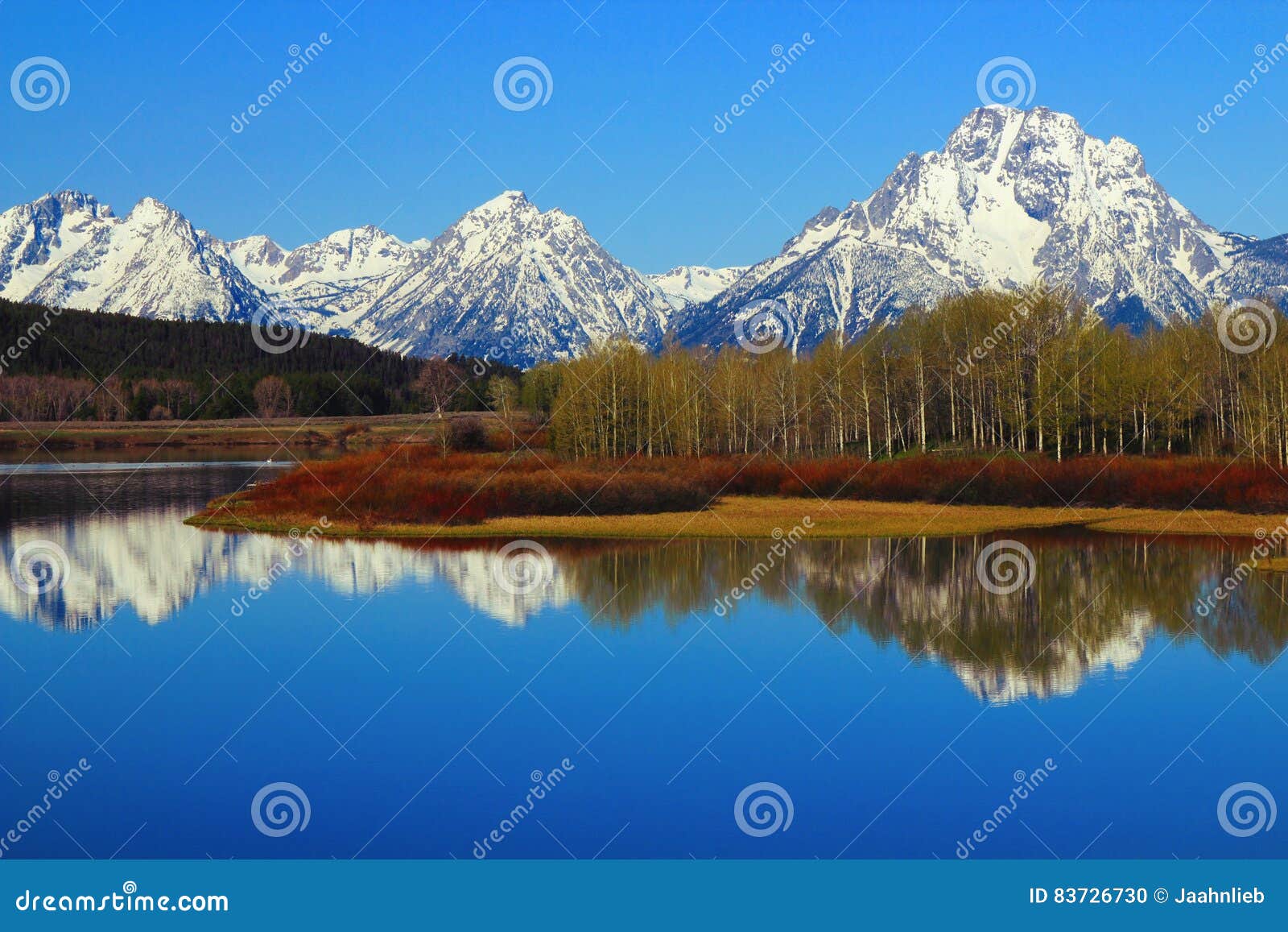 rocky mountains range reflected in oxbow bend of the snake river, grand teton national park, wyoming