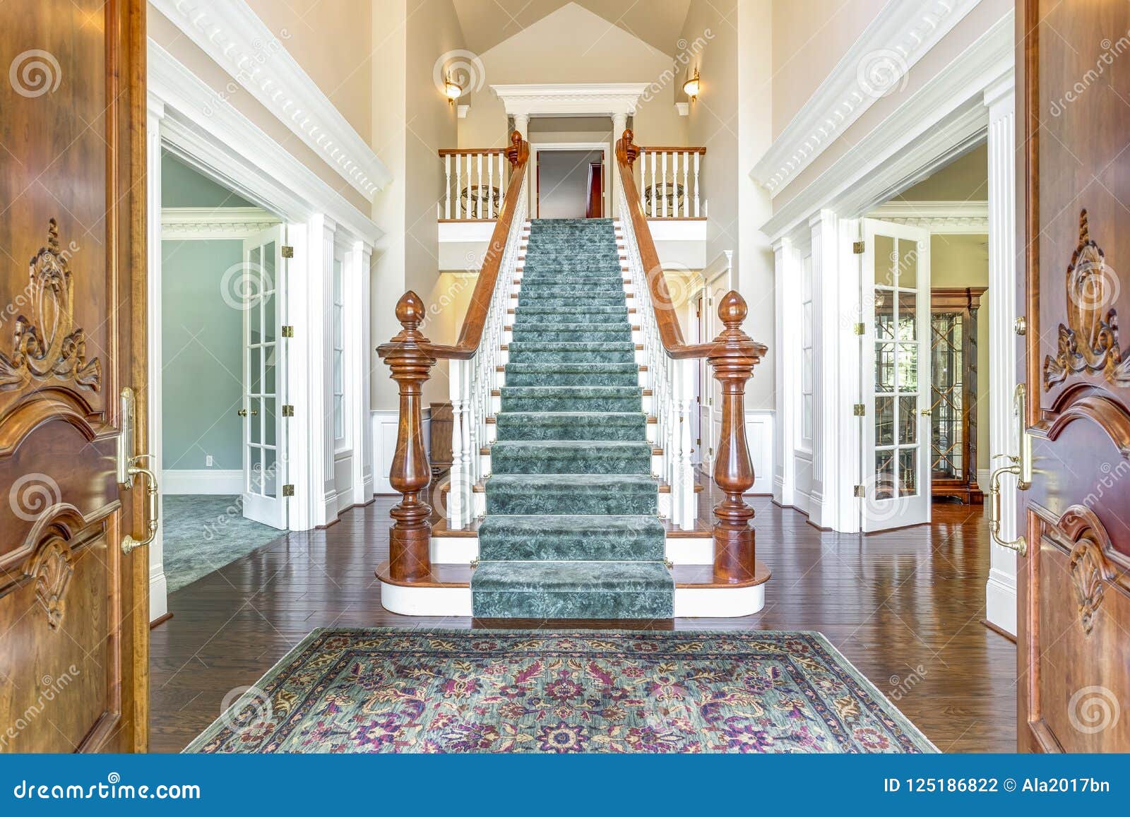 grand two story foyer with elegant staircase.