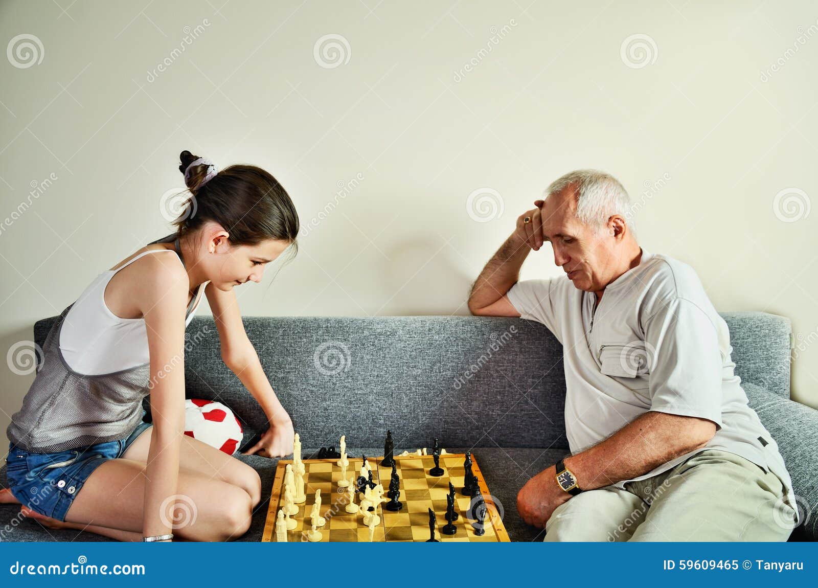 Granddaughter And Grandpa Playing Chess Front View Stock Image Im