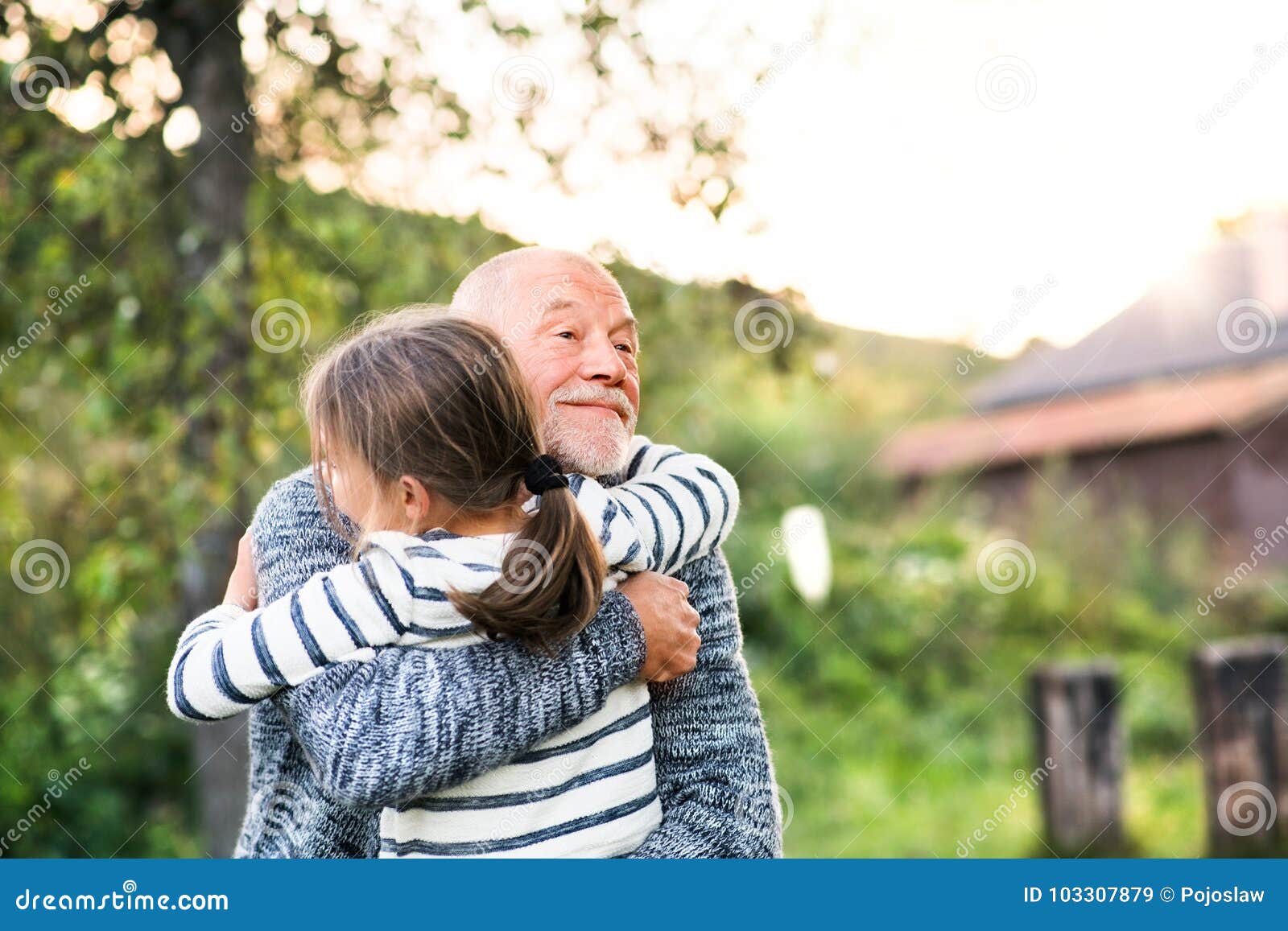 grandfather giving his grandaughter a hug.