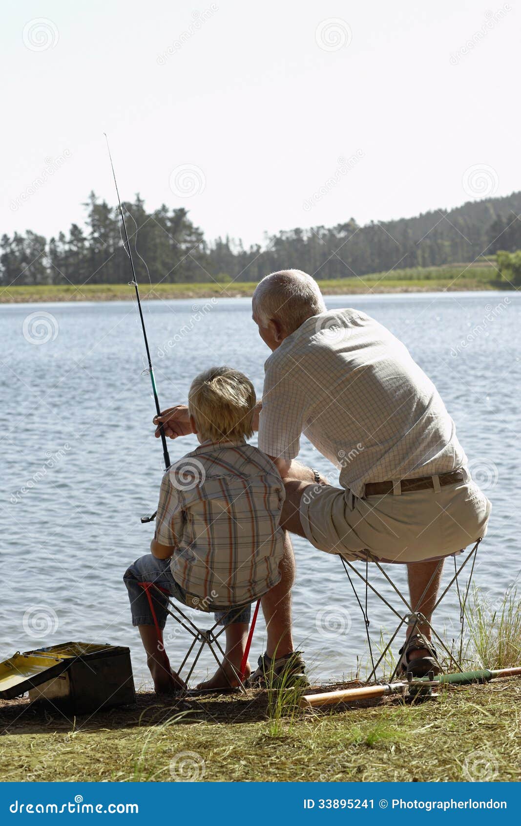 Grandfather And Grandson Fishing By Lake Royalty-Free Stock Photography ...