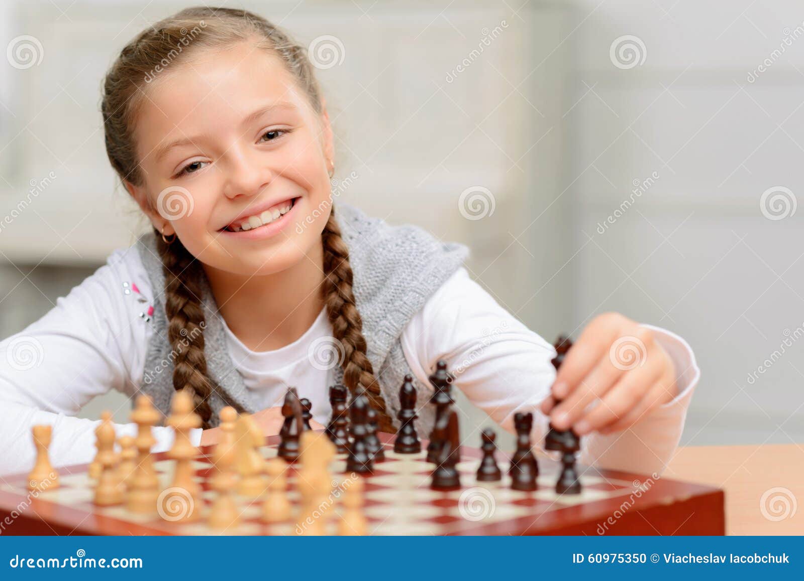 grandfather playing chess with little girl