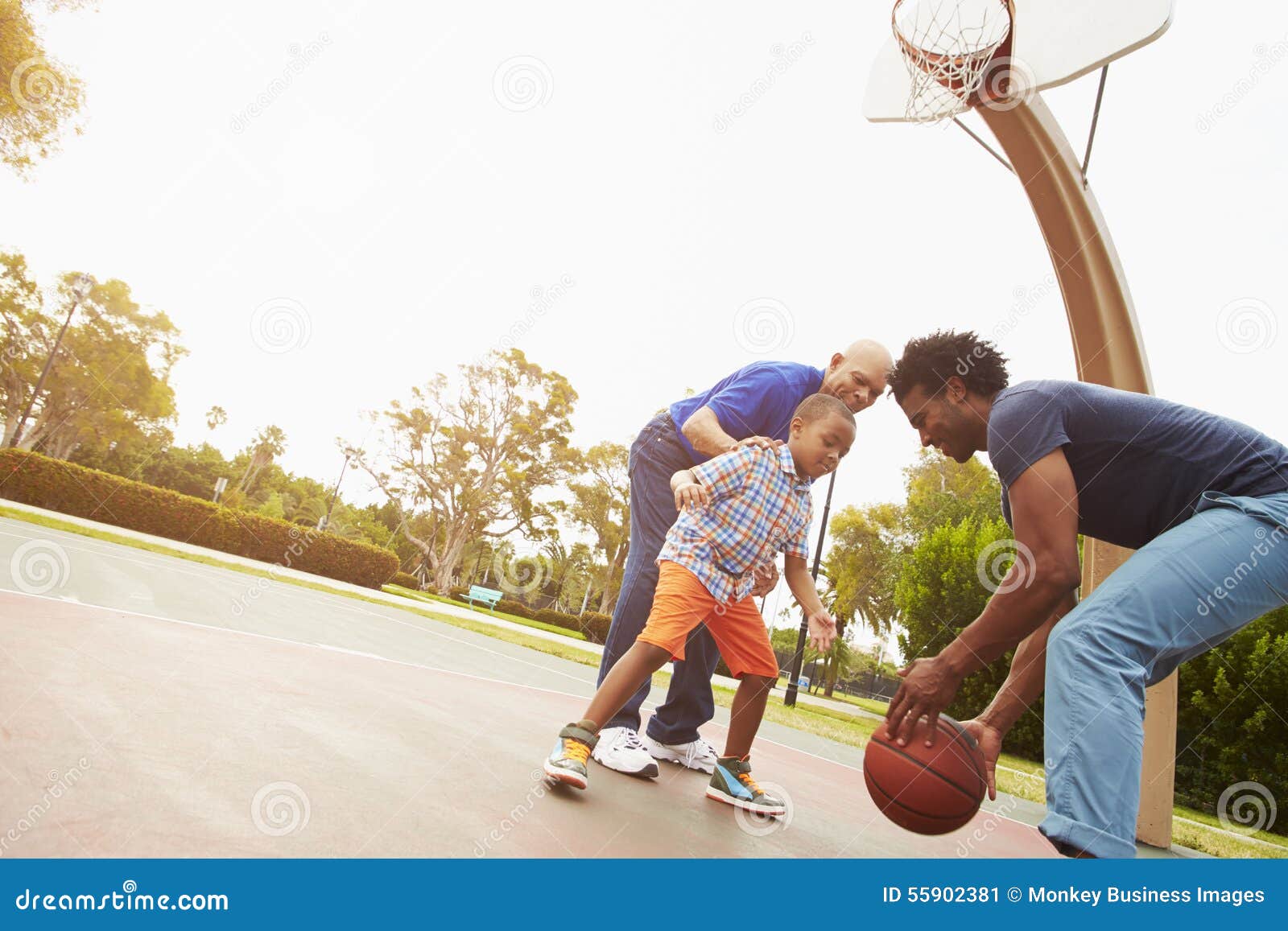 Grandfather with Son and Grandson Playing Basketball Stock Image