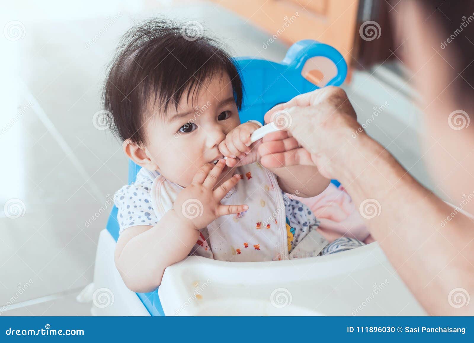 Grandmother Feeding Cute Asian Baby Girl With A Spoon Stock Photo