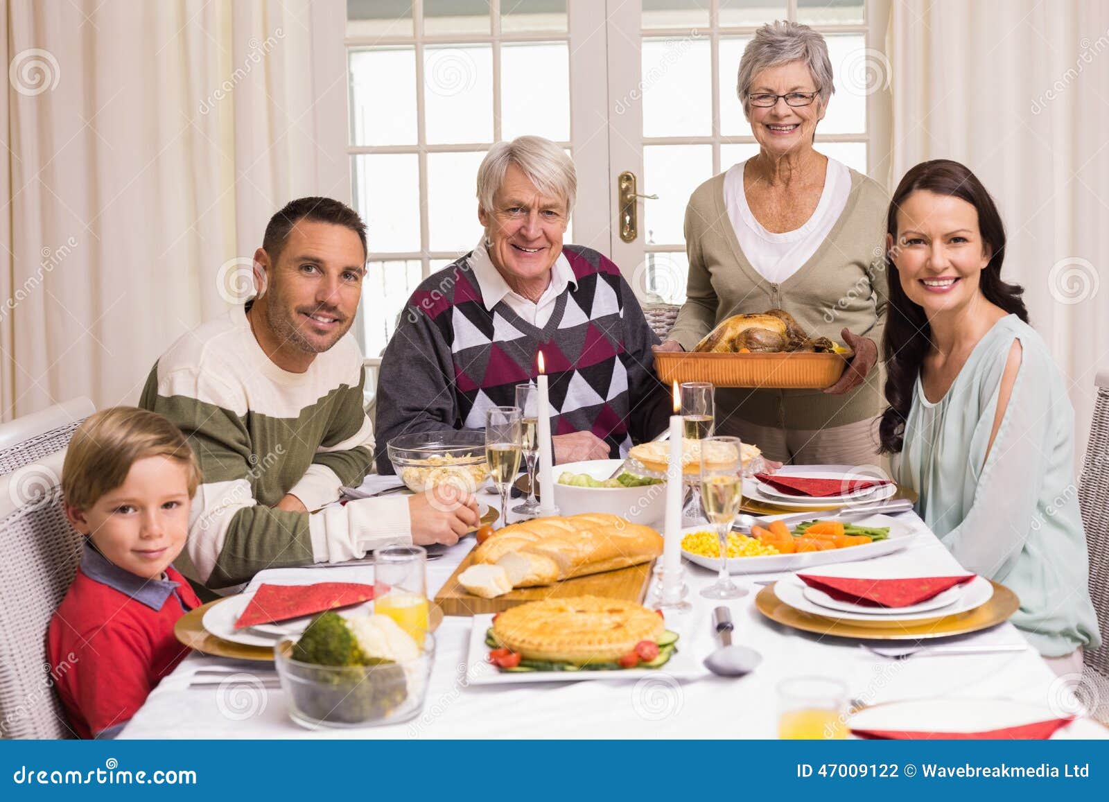 Grandmother Holding Turkey Roast with Family at Christmas Stock Photo ...