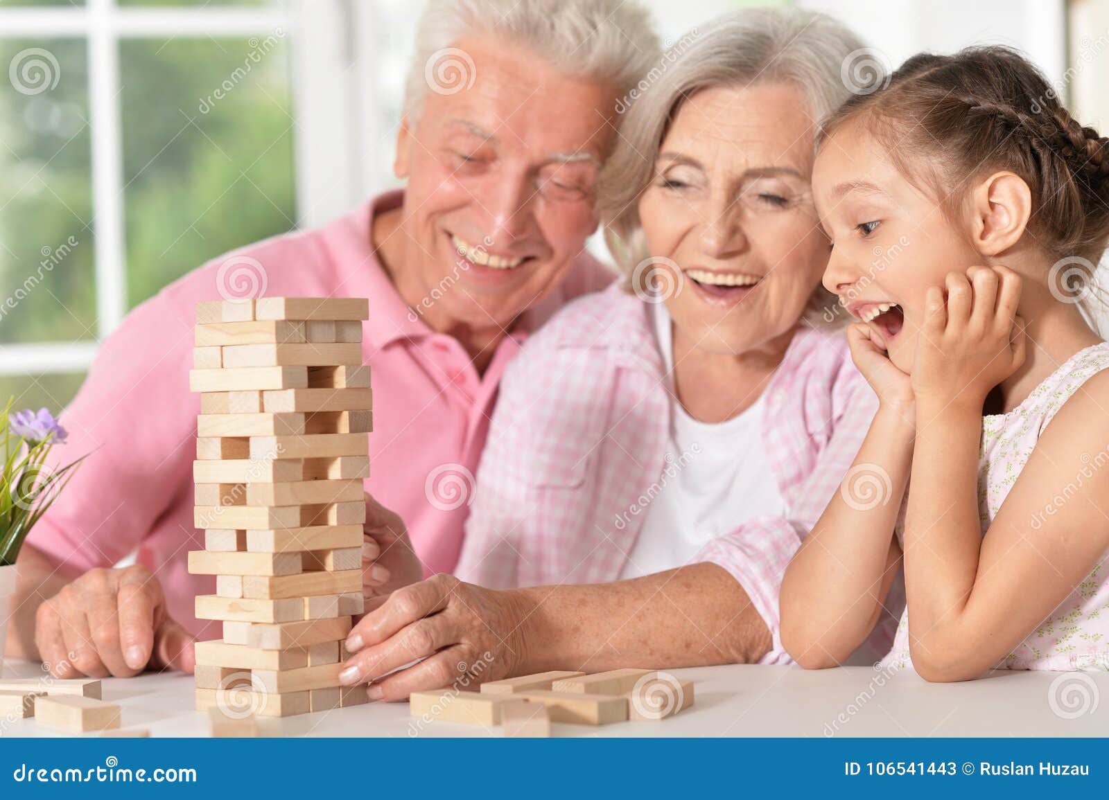grandparents playing with her little granddaughter