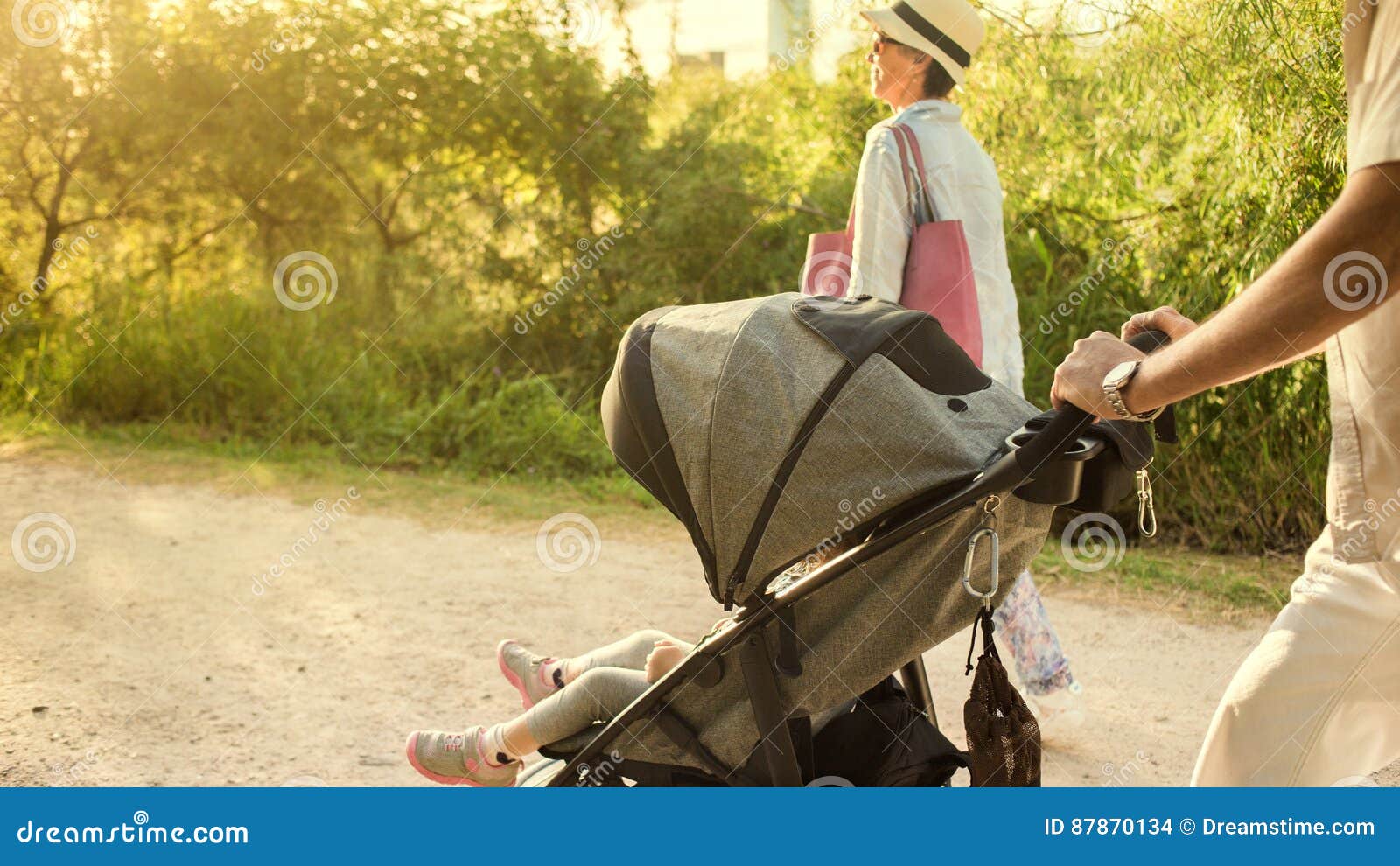 Grandparents Pushing Stroller. Stock Photo Image of grandfather