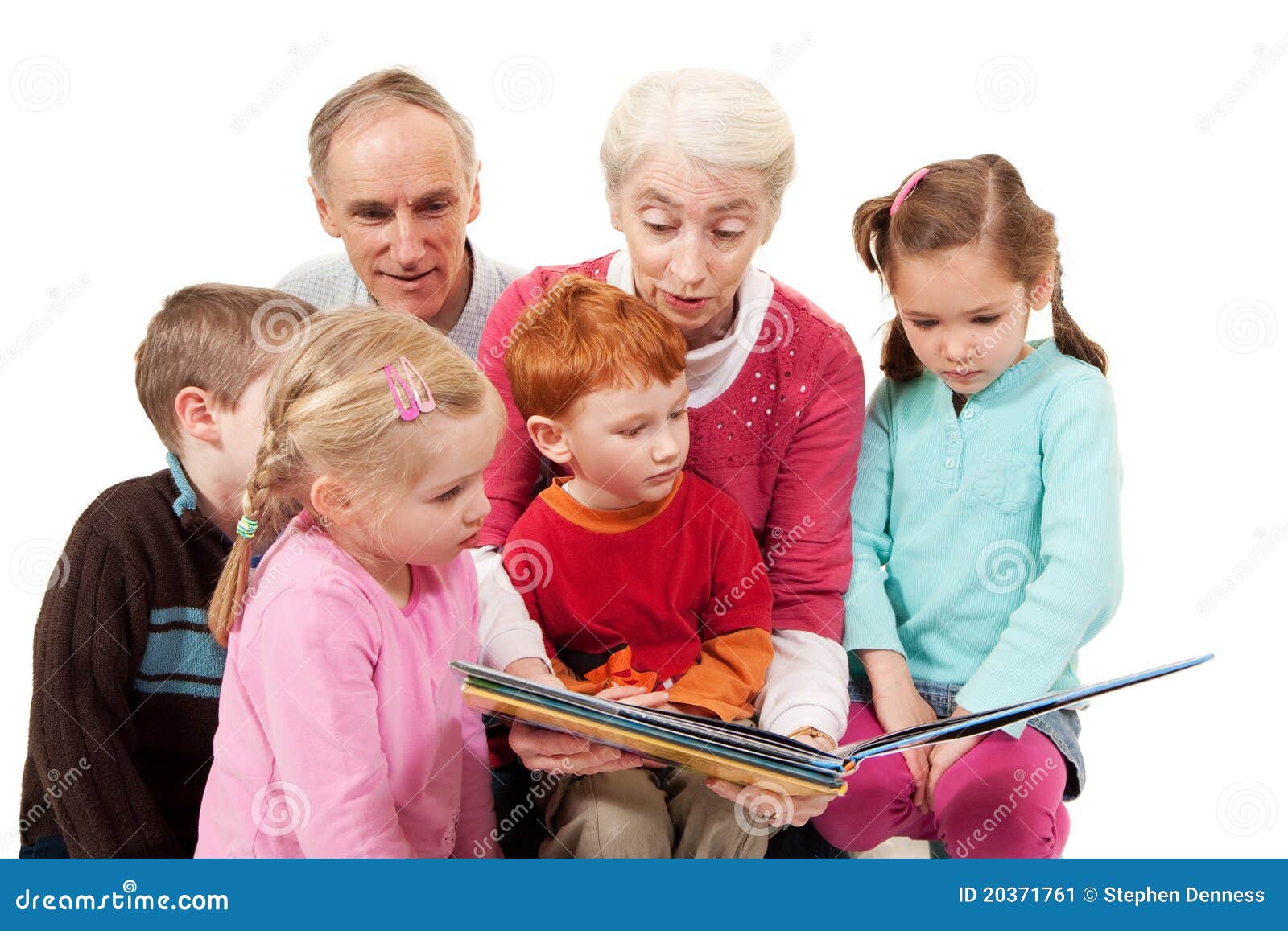 grandparents reading kids story book to children