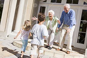 Grandparents Welcoming Grandchildren On Visit Royalty Free Stock Photo 
