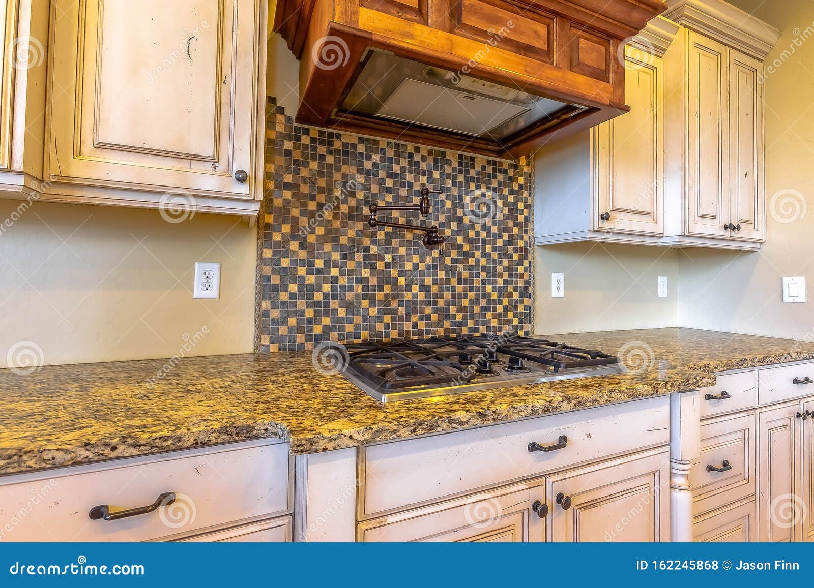 Granite Kitchen Counter With Hob And Splash Back Stock Photo