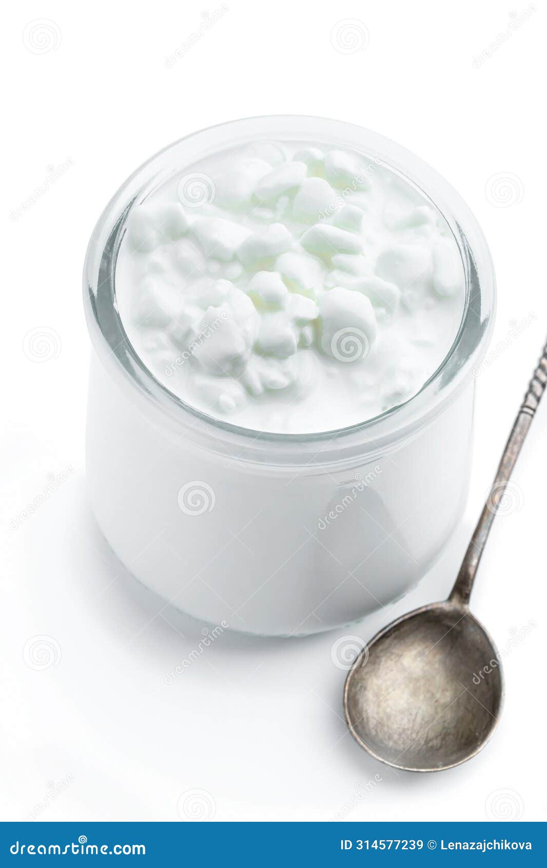 granular cottage cheese with cream in a glass jar  on white