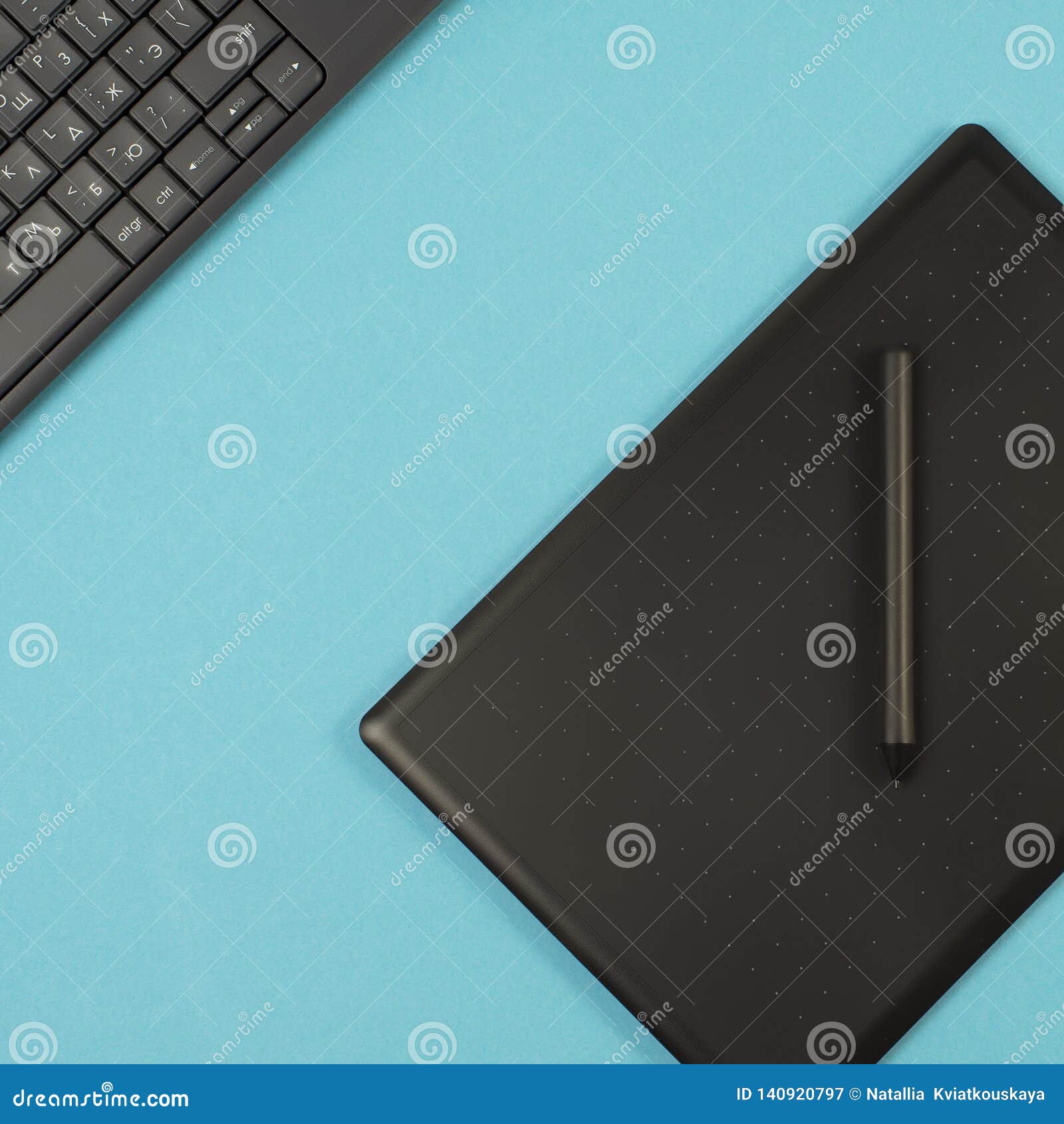 Graphics Tablet And Keyboard On A Blue Background. Space For Text