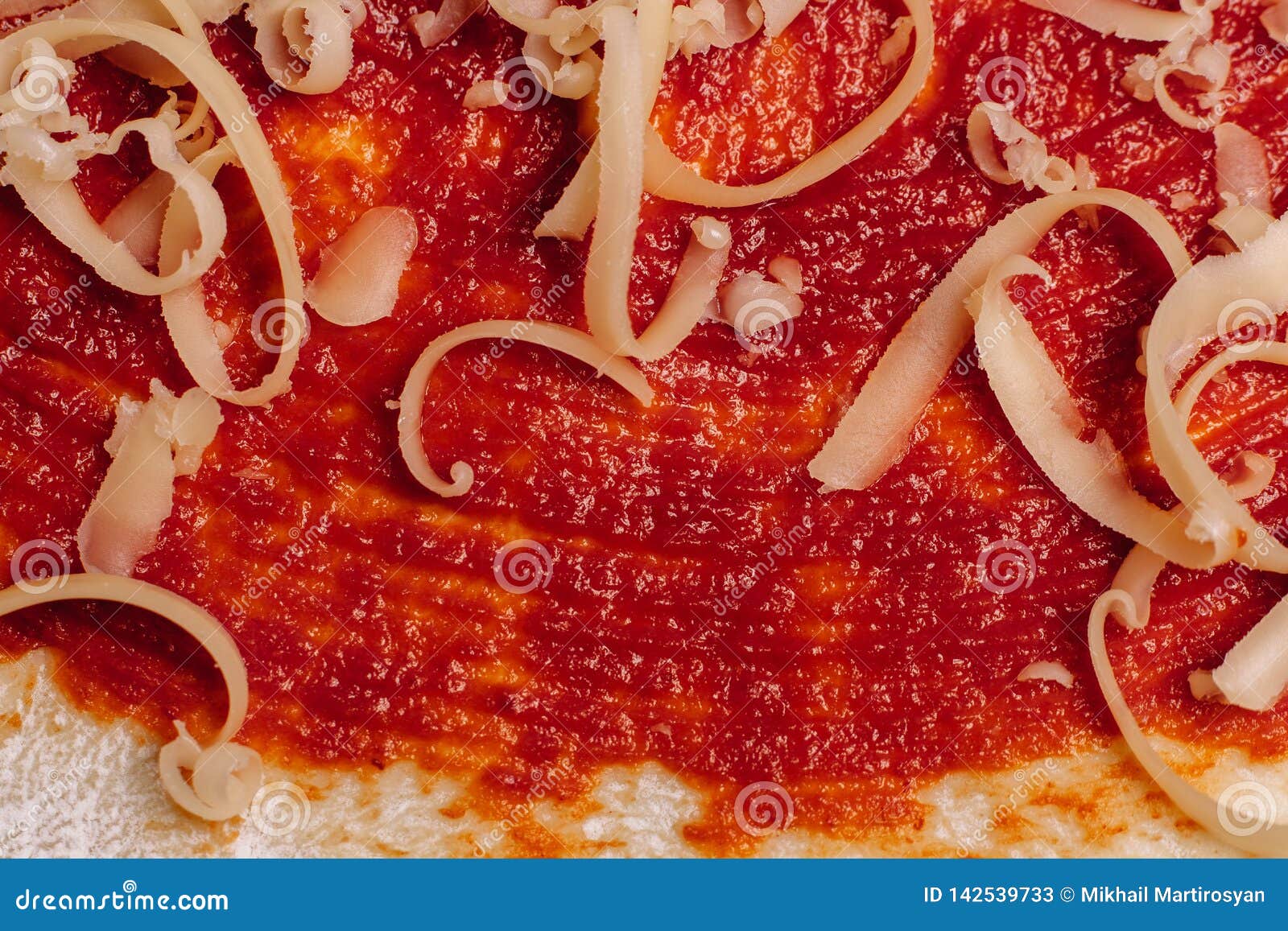 Grated Cheese for Pizza Close Up on Ketchup Coated Dough Stock Image