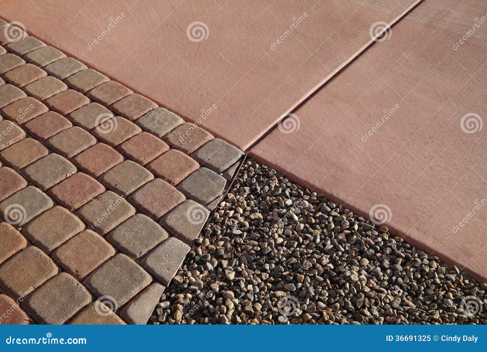 Gravel pavers concrete. A picture of gravel paver blocks and concrete where they all come together.