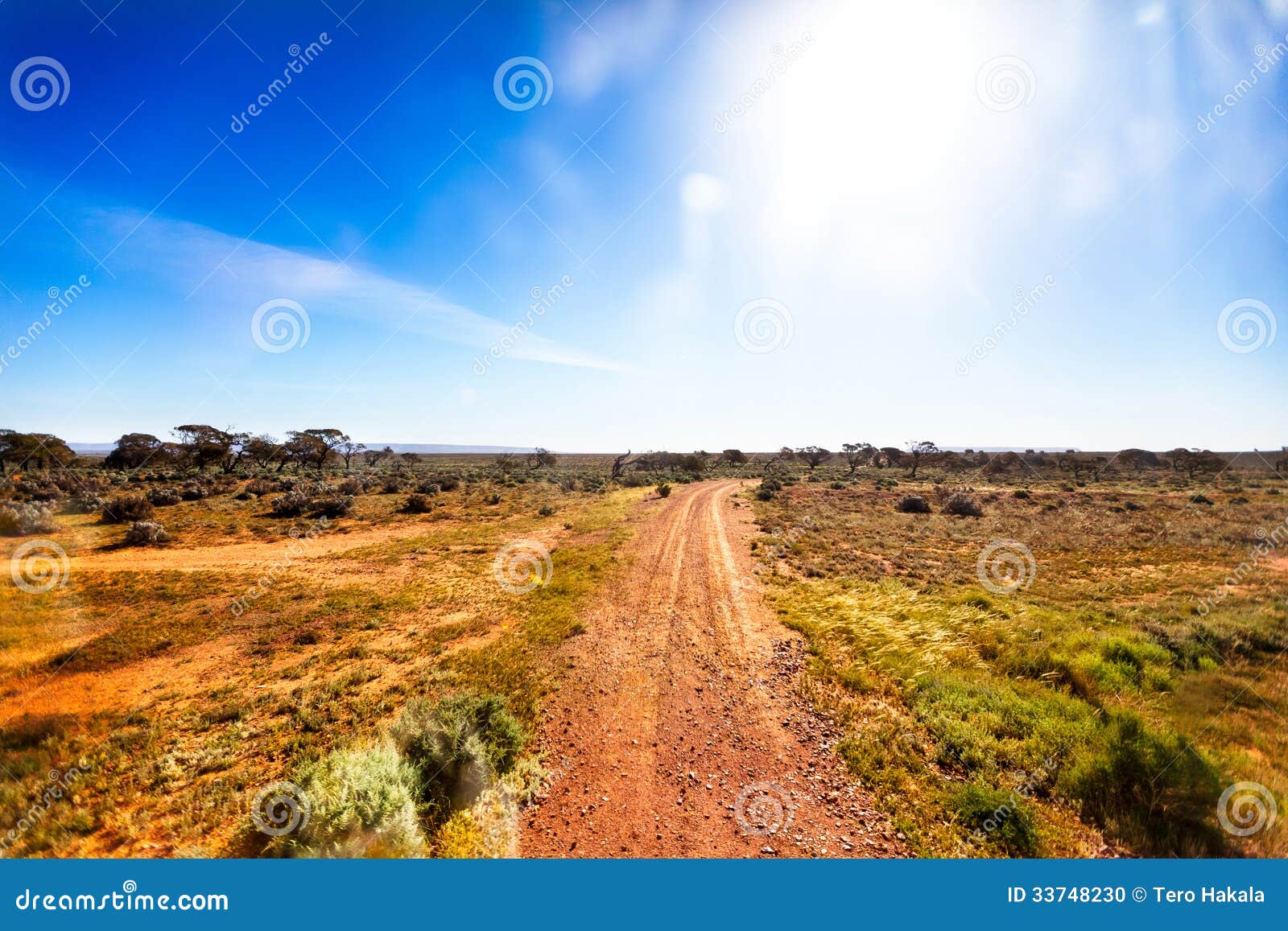gravel road in australian outback in bright sunshine