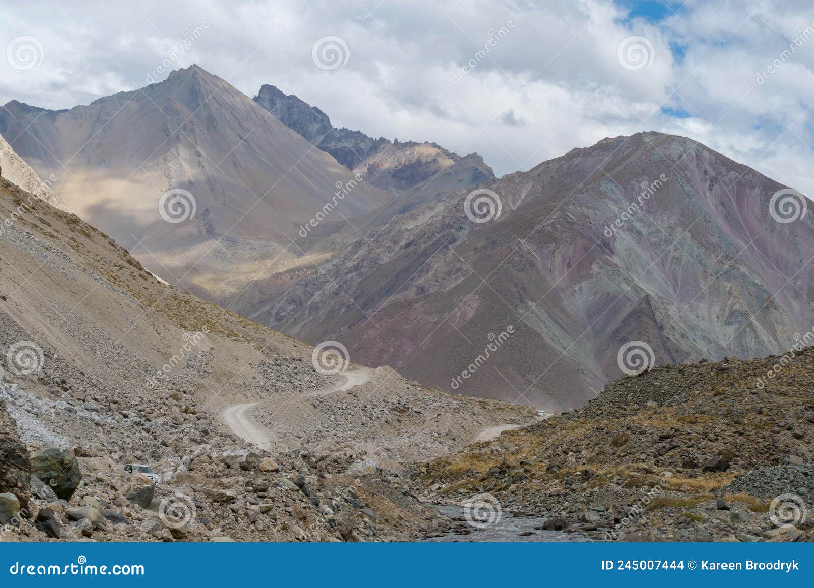 a gravel road leading through the andes mountain range en route to valle de colina, chile, south america