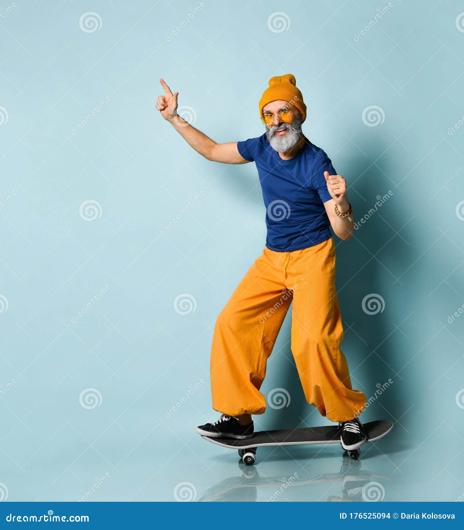 Aged Man in T-shirt, Sunglasses, Orange Pants, Hat, Gumshoes. Riding ...