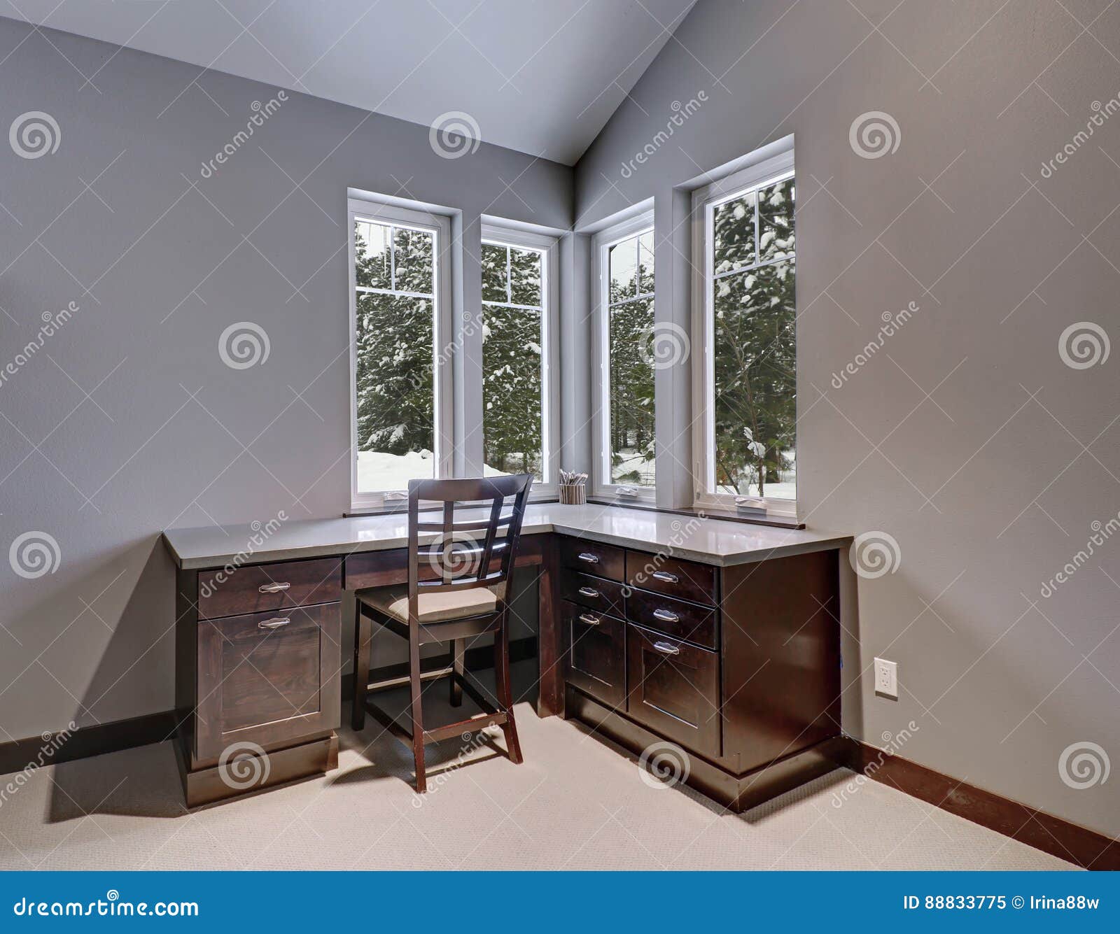 Gray And Blue Home Office Features A Vaulted Ceiling Stock Image