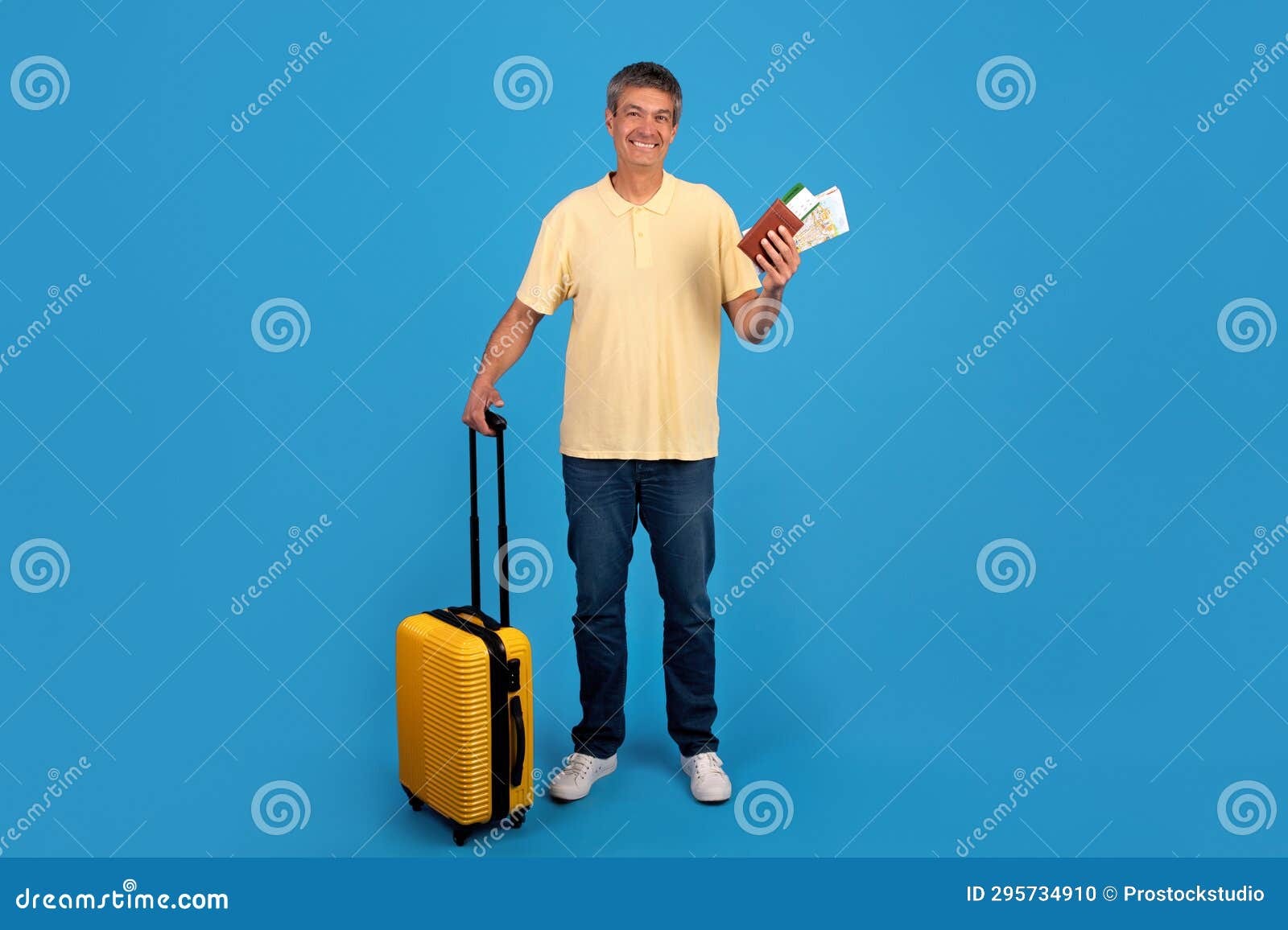 gray globetrotter man with suitcase and tickets on blue background