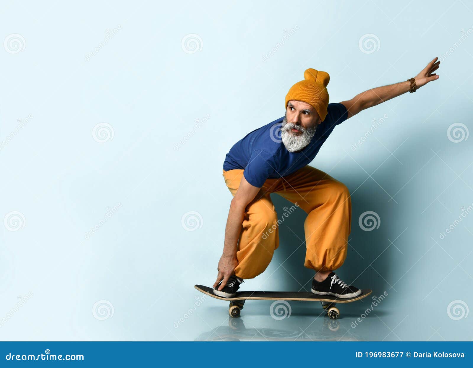 Aged Man in T-shirt, Orange Pants, Hat, Gumshoes. Riding Black ...