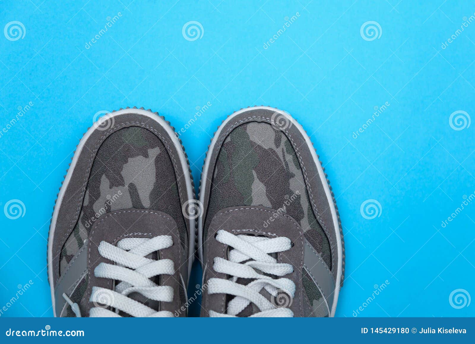 Gray Sneakers on a Blue Background Stock Photo - Image of foot, kicks ...