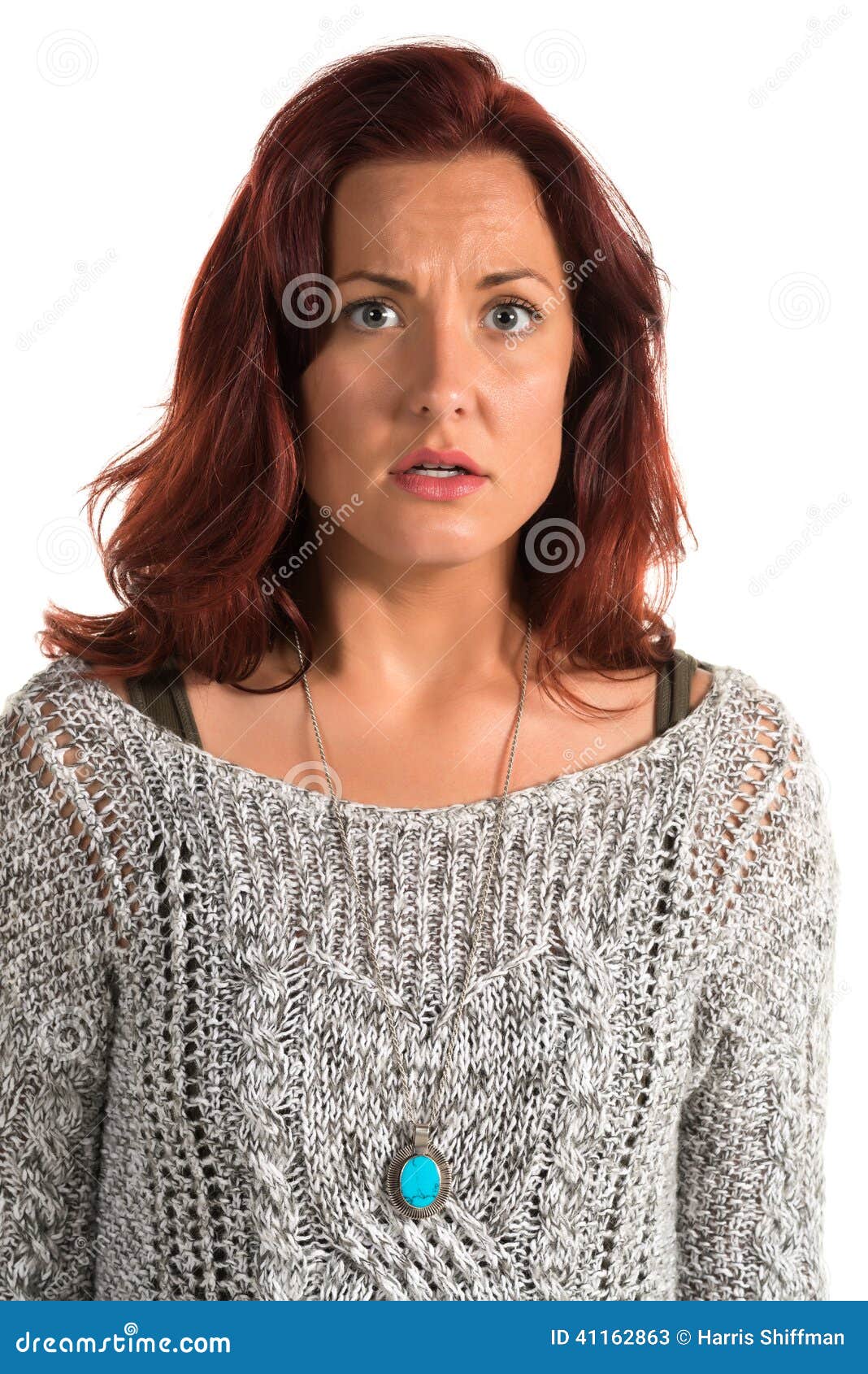 Pretty redheaded woman in a gray sweater