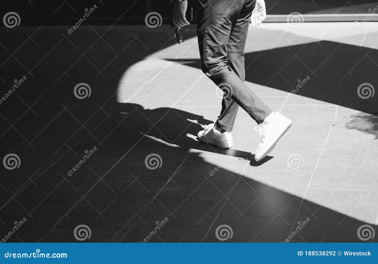 Grayscale Shot of a Man Walking Outside Stock Photo - Image of ...