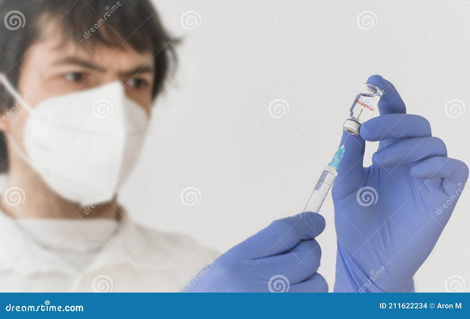graz,austria-26.01.2021: doctor holding a vaccine bottle and syringe, beginning of mass vaccination with the moderna covid-19