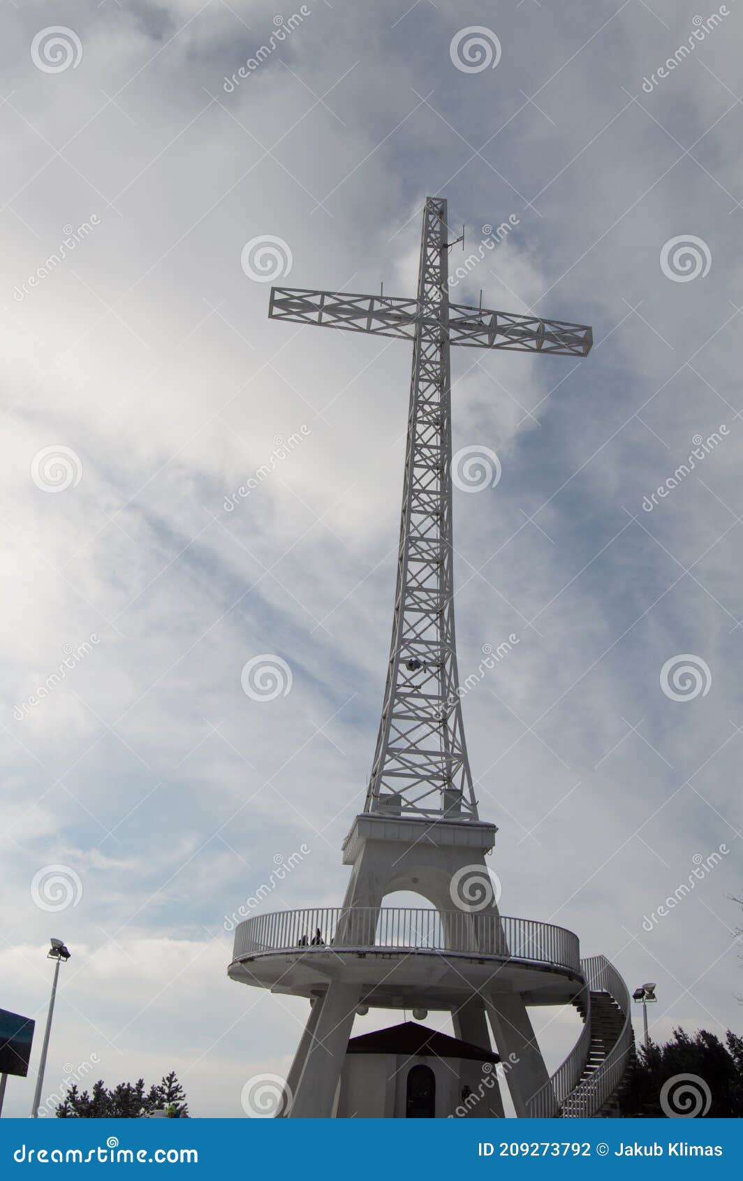 a great cross-d structure on top of a mountain overlooking the city.
