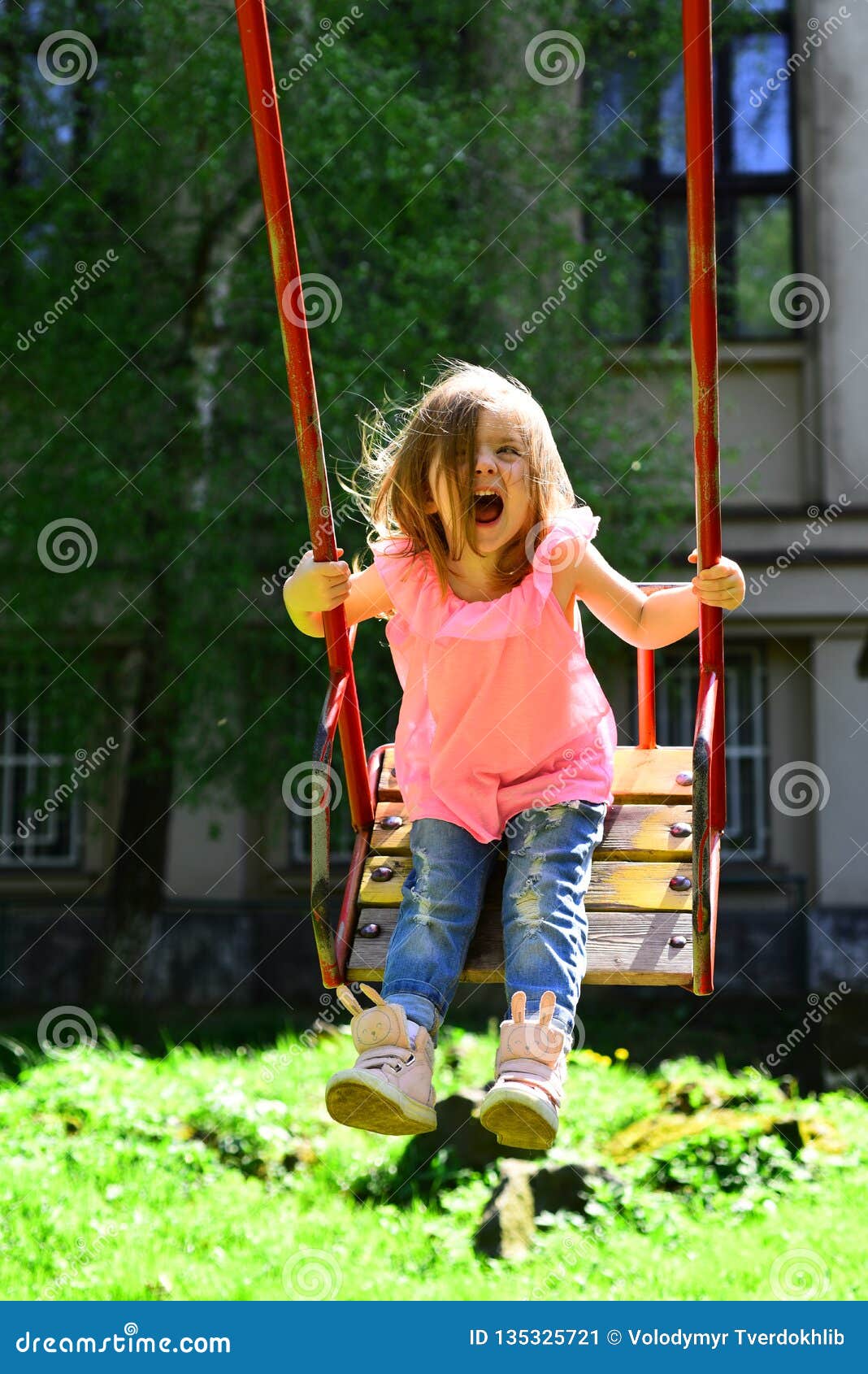 Great pleasure. romantic little girl on the swing, sweet dreams. Happy laughing child girl on swing. Small kid playing in summer. childhood daydream .teen freedom. Playground in park.