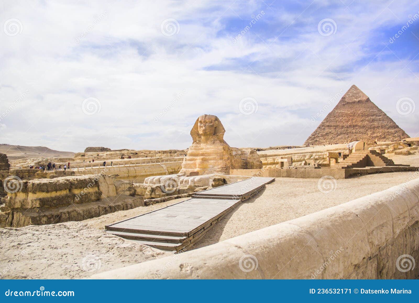 great sphinx against the background of the pyramids of the pharaohs cheops, khafren, and mikerin in giza