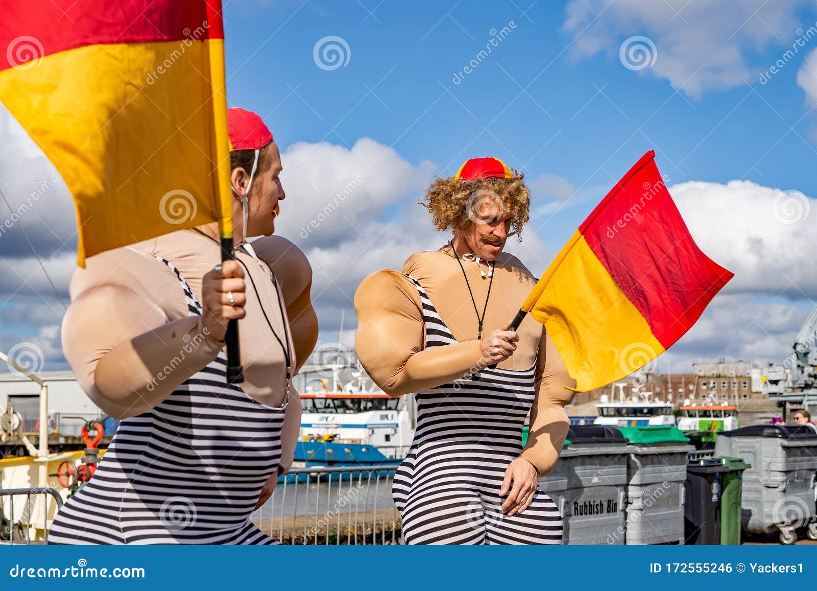 A Couple Dressed As Novelty Lifeguards Waving Flags At The Annual Maritime Festival Editorial Photo Image Of Beach Great
