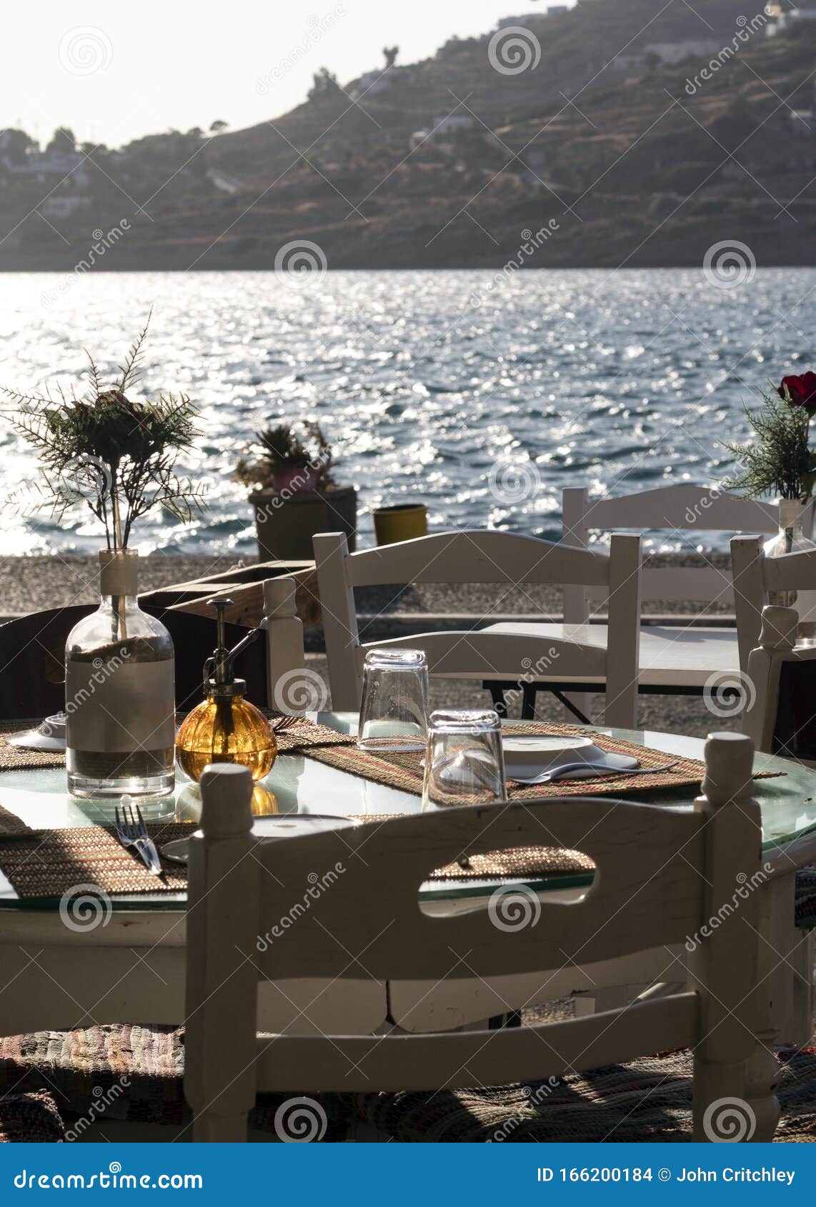 Vertical Shot of Tables and Chairs at a Greek Taverna on the Island of ...