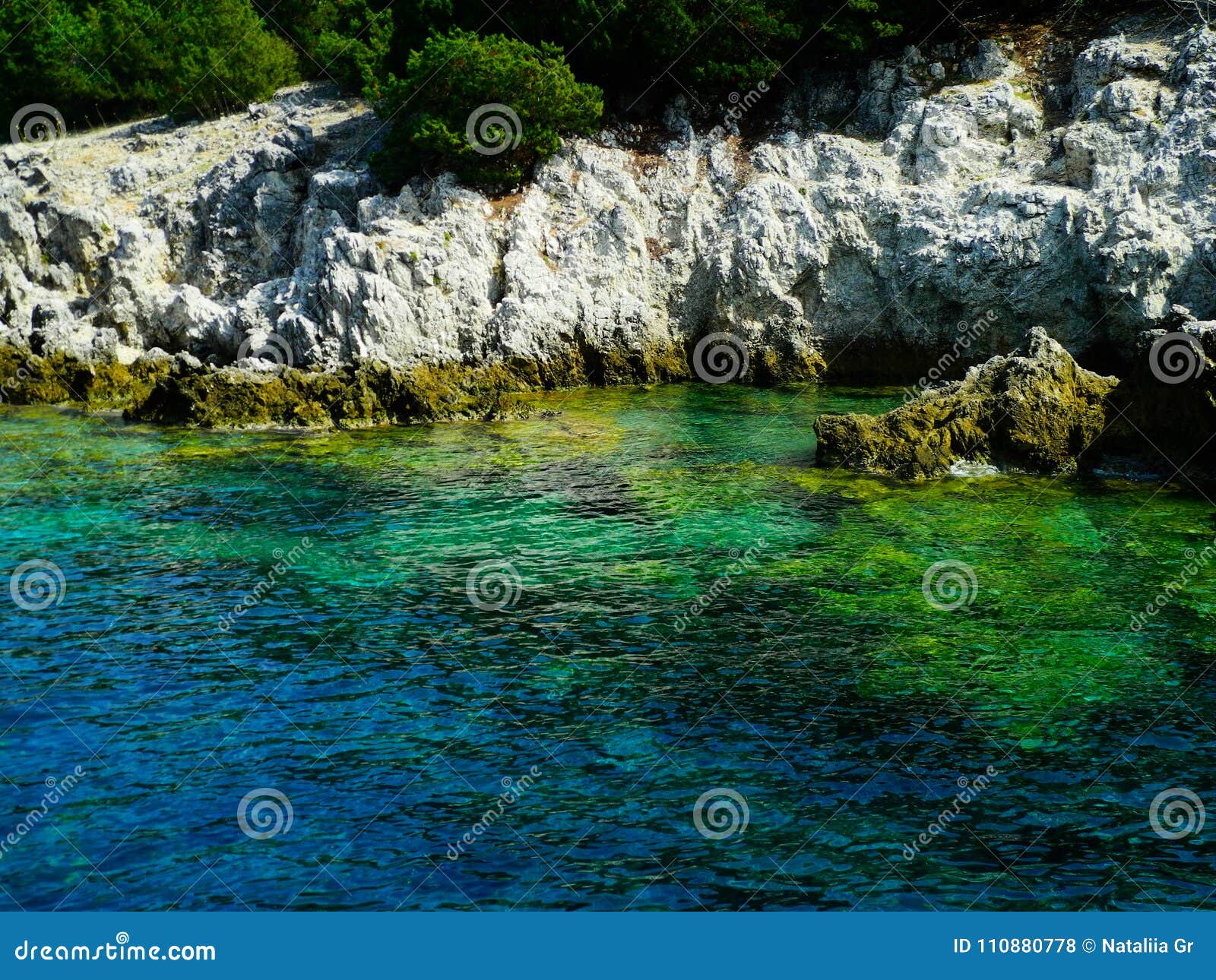 greece rocky coasline, green, blue, turqouise, aquamarine water, mediterranean sea.