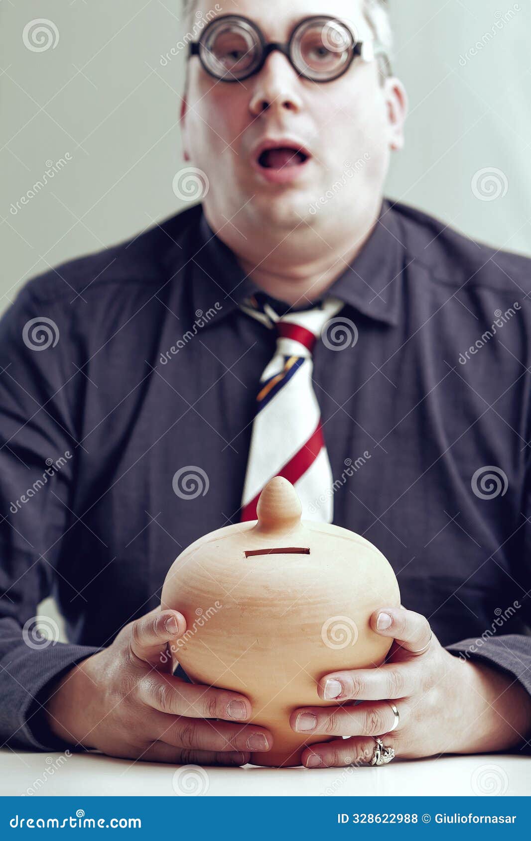 greedy accountant holding empty piggy bank looking dumb
