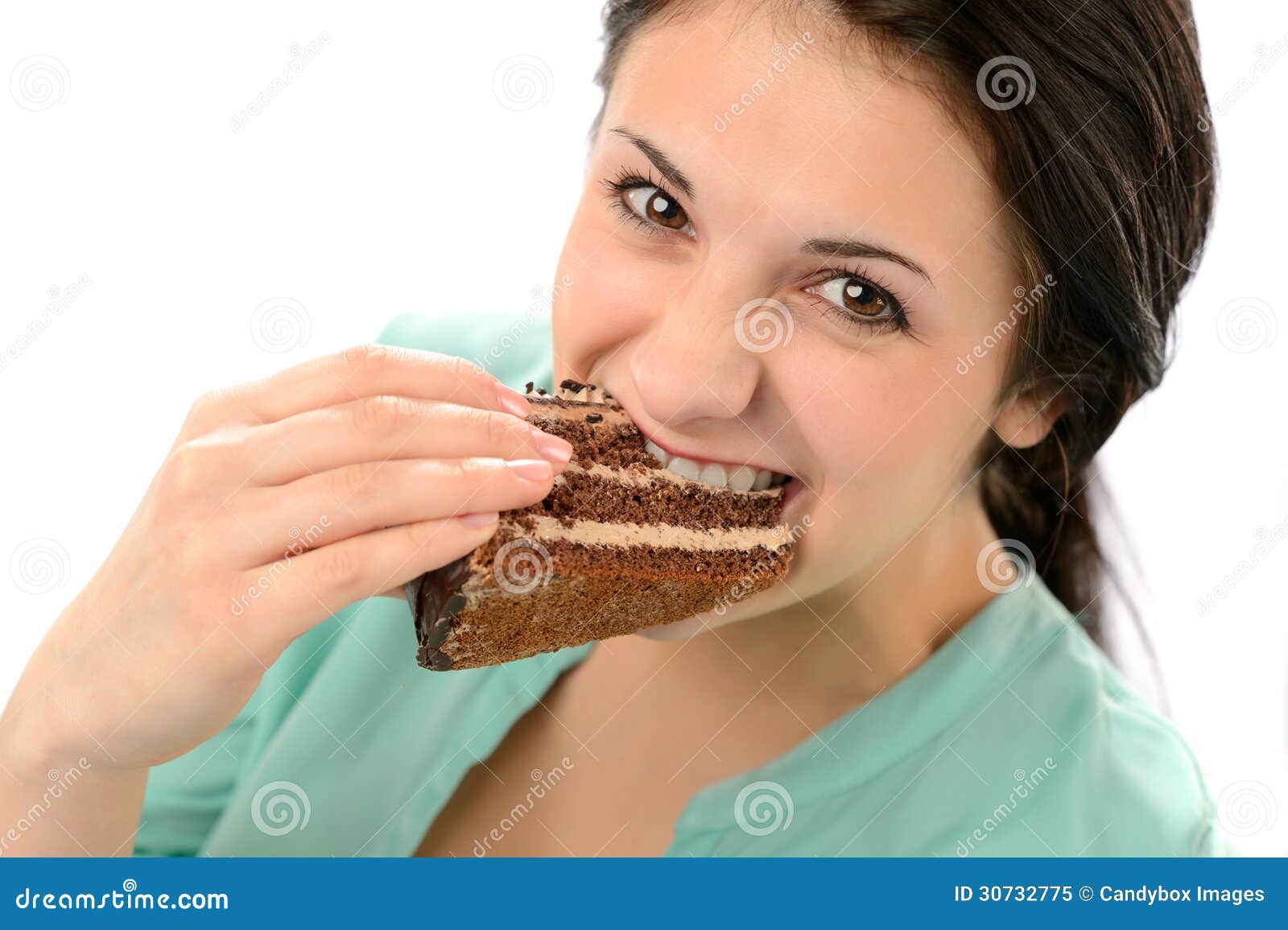 greedy young woman eating tasty cake