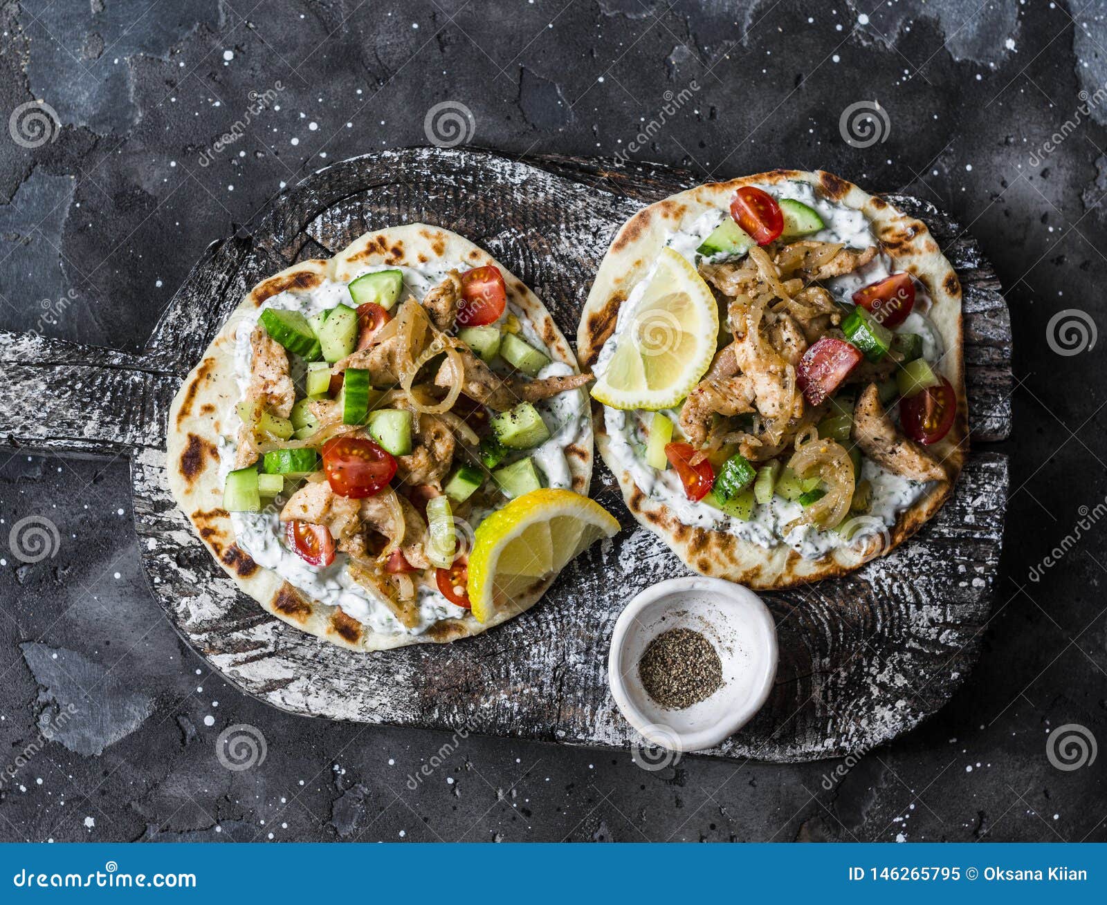 Greek Chicken Gyros Flatbread on a Rustic Cutting Board on a Dark