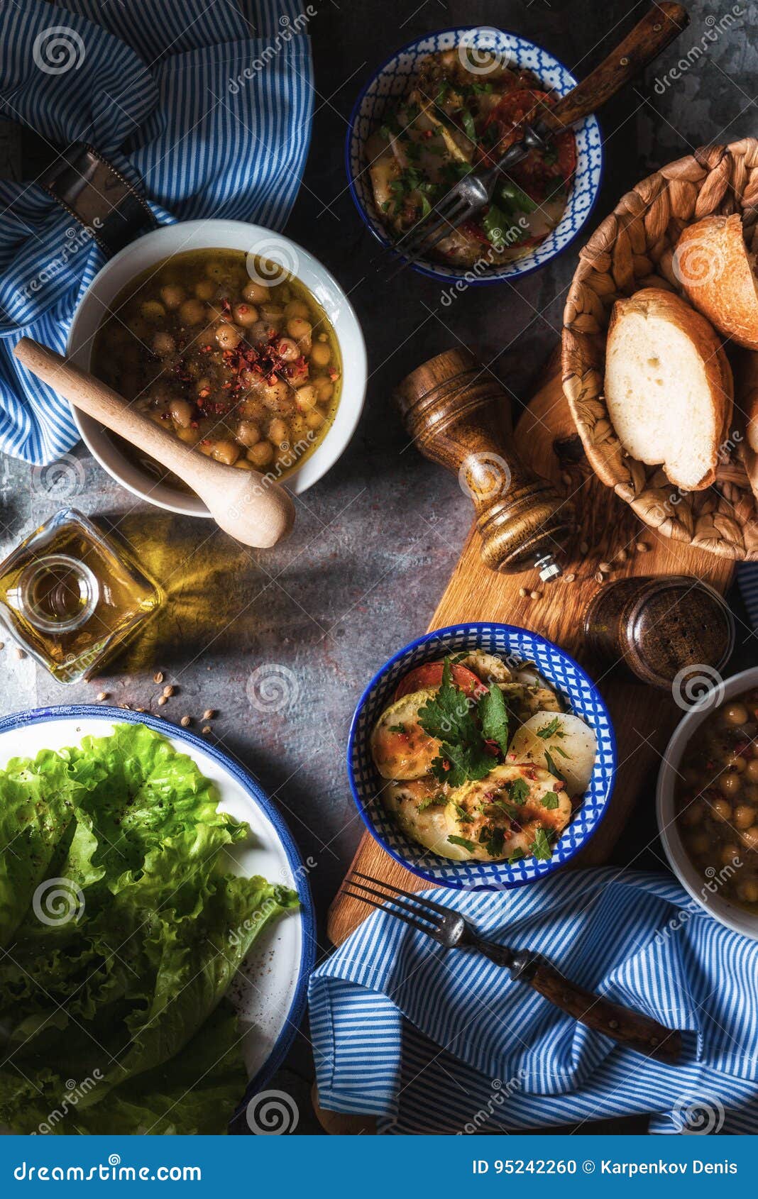 greek dinner with revithia and briam on the stone background vertical