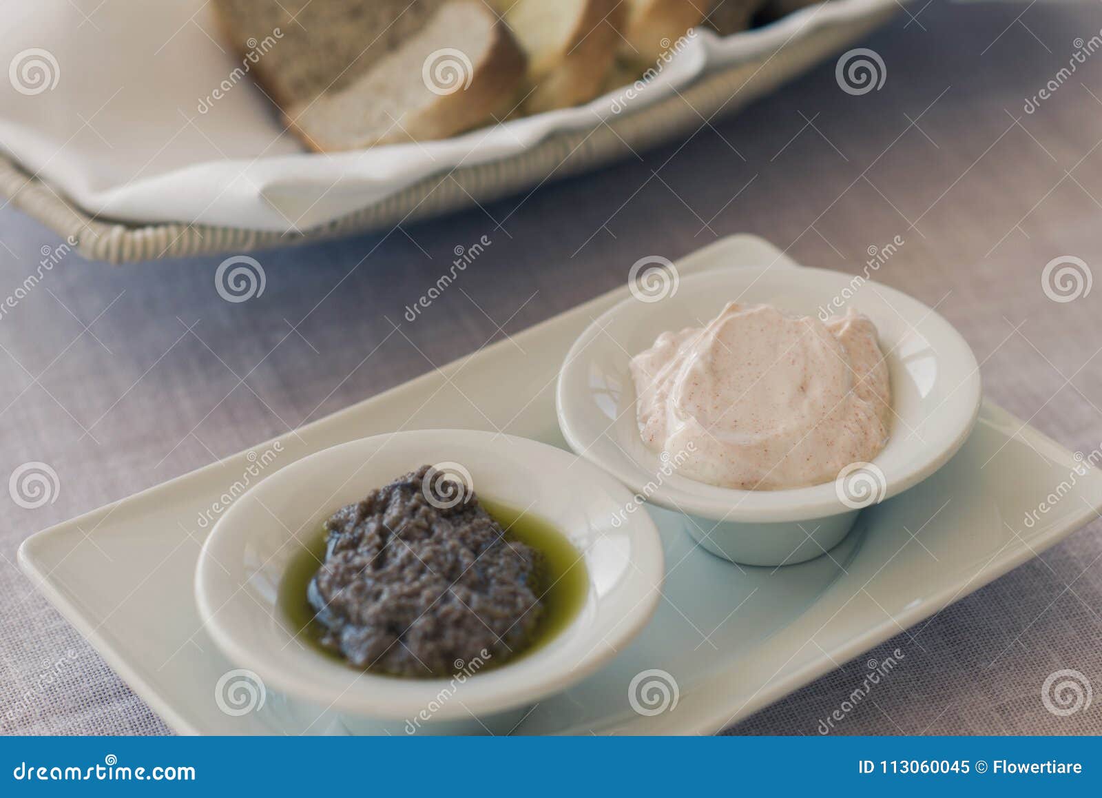 Greek Olive Paste and Tzatziki Sauce with Bread on the Table Stock