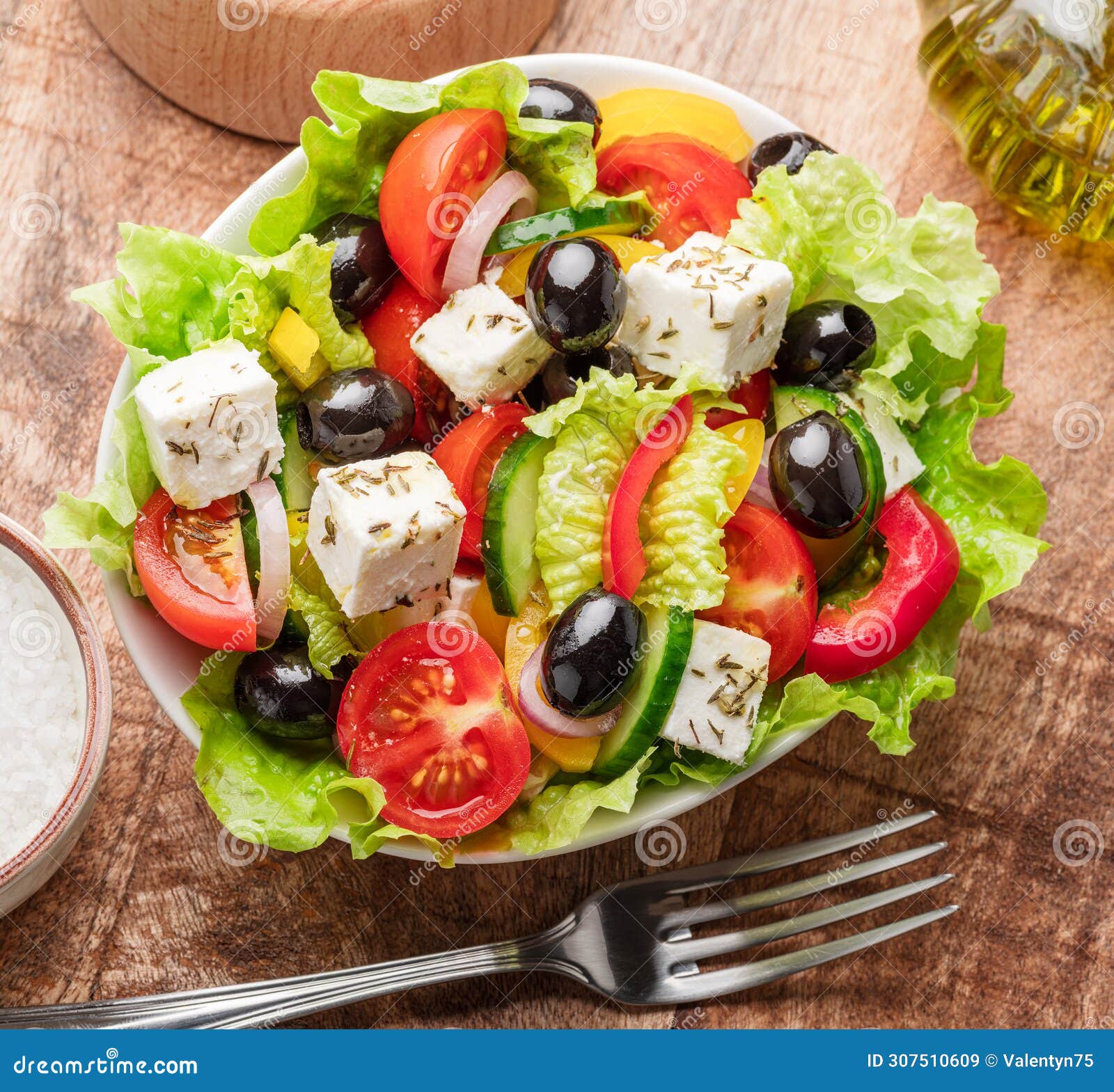 greek salad on wooden table served and ready to eat