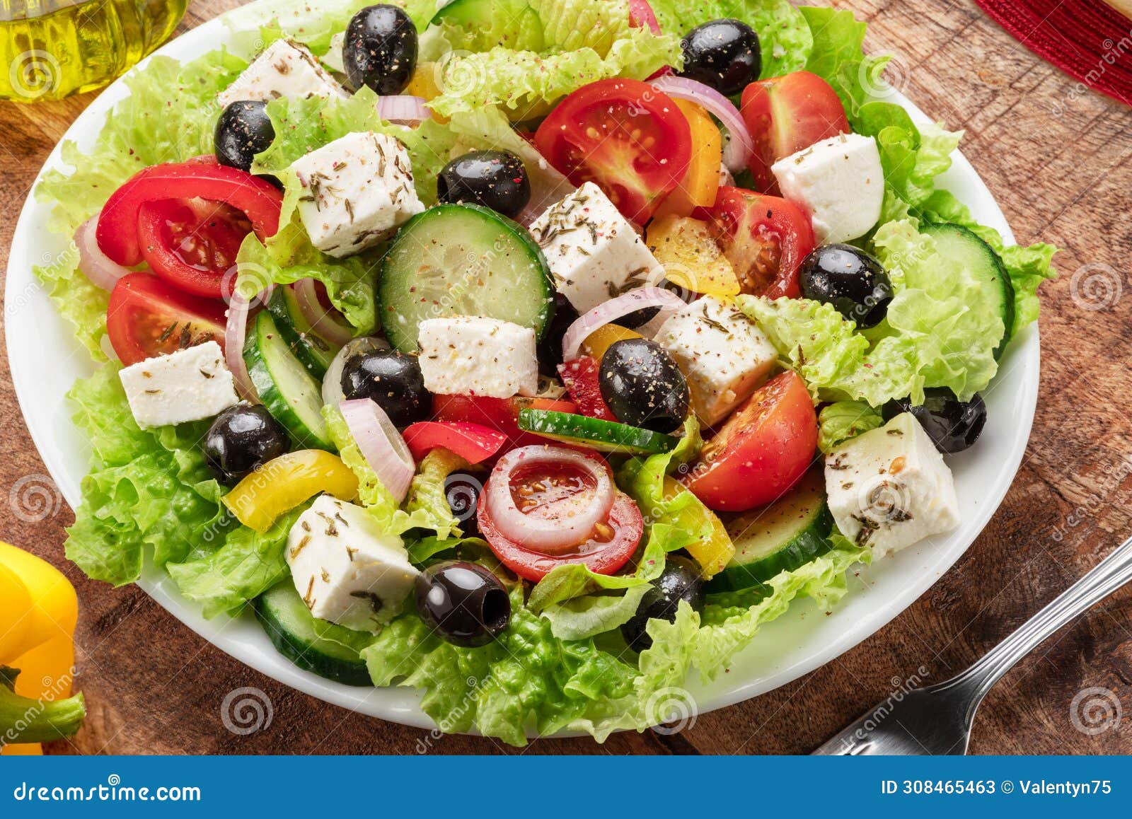 greek salad on wooden table served and ready to eat